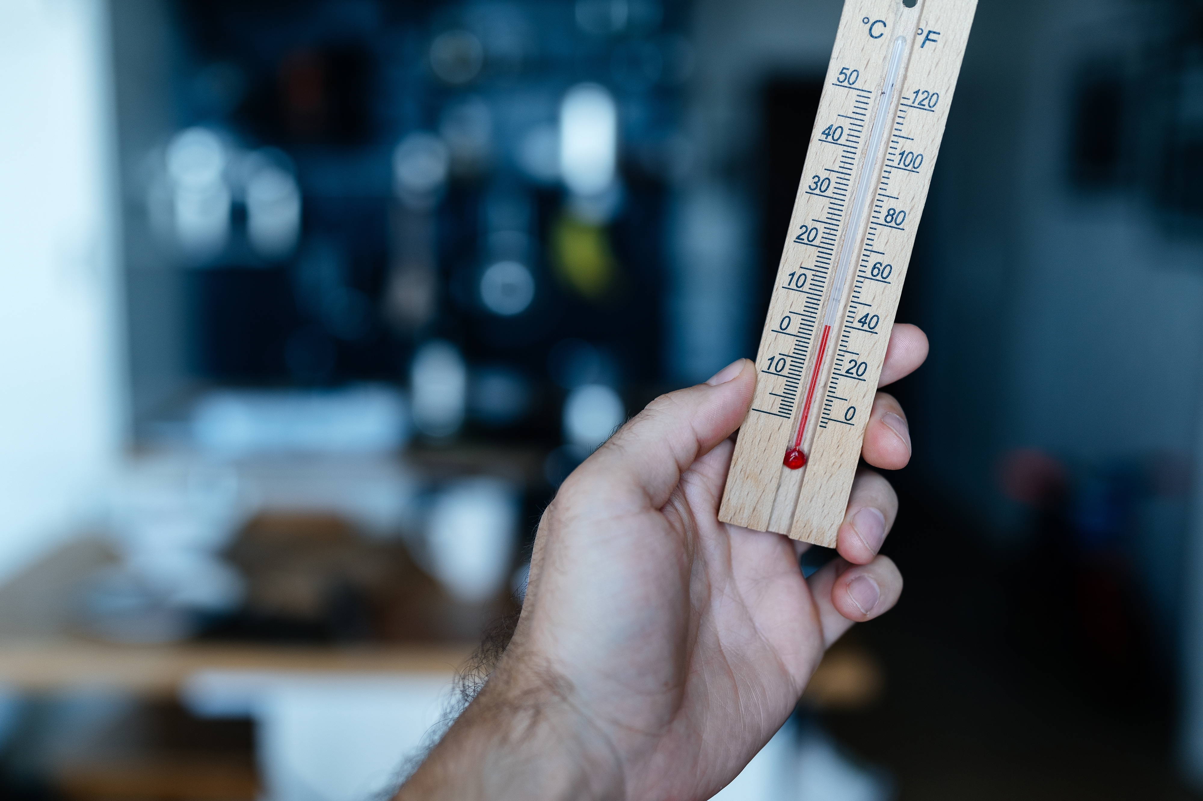 Energy,Crisis,In,Europe.,A,Man's,Hand,Holds,A,Thermometer