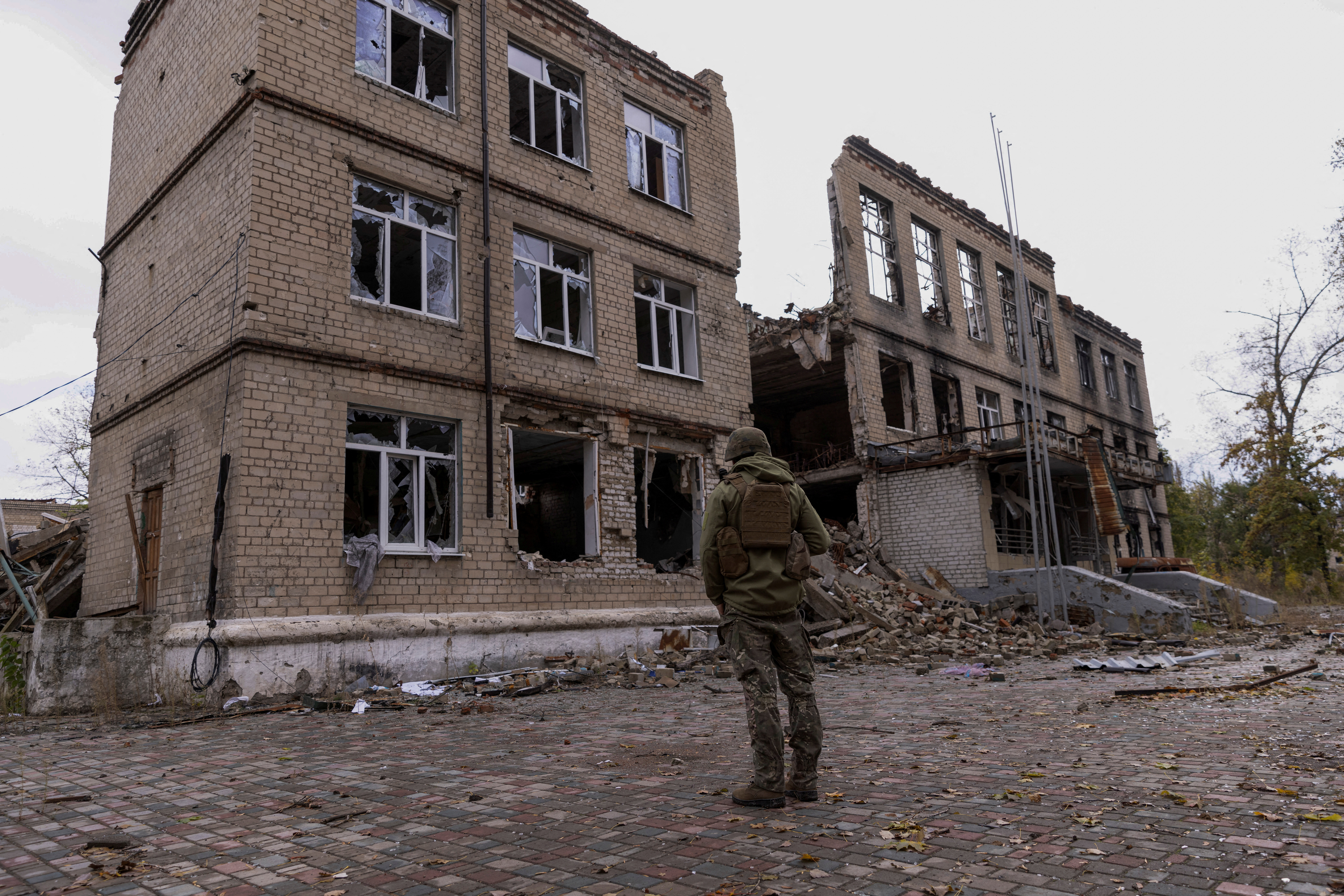 FILE PHOTO: A police officer stands in front of a damaged building in Avdiivka