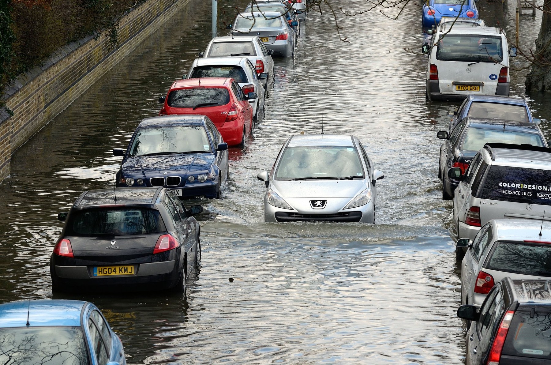 Parked cars in flooded suburban road London