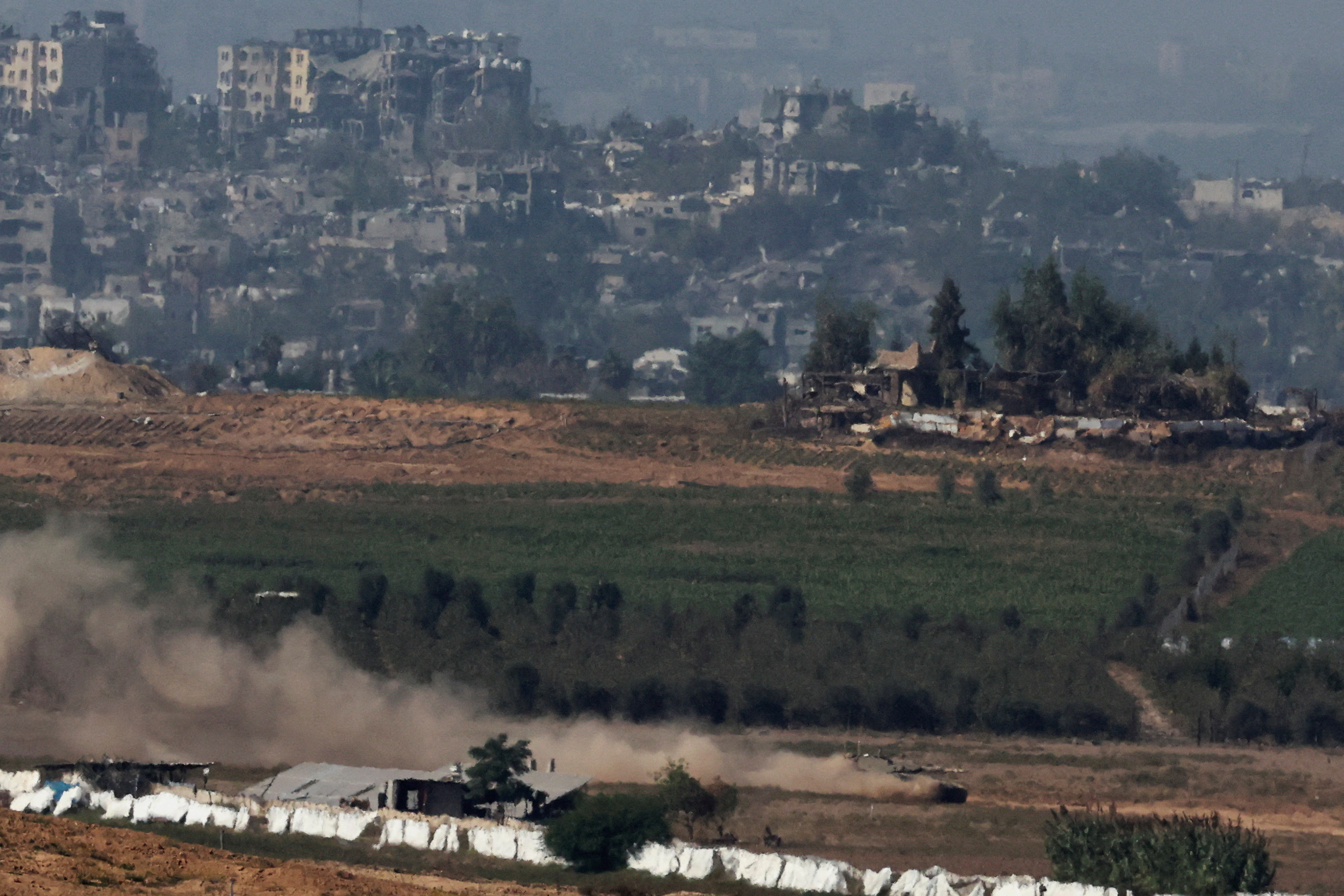An Israeli tank manoeuvres at the border between Israel and the Gaza Strip