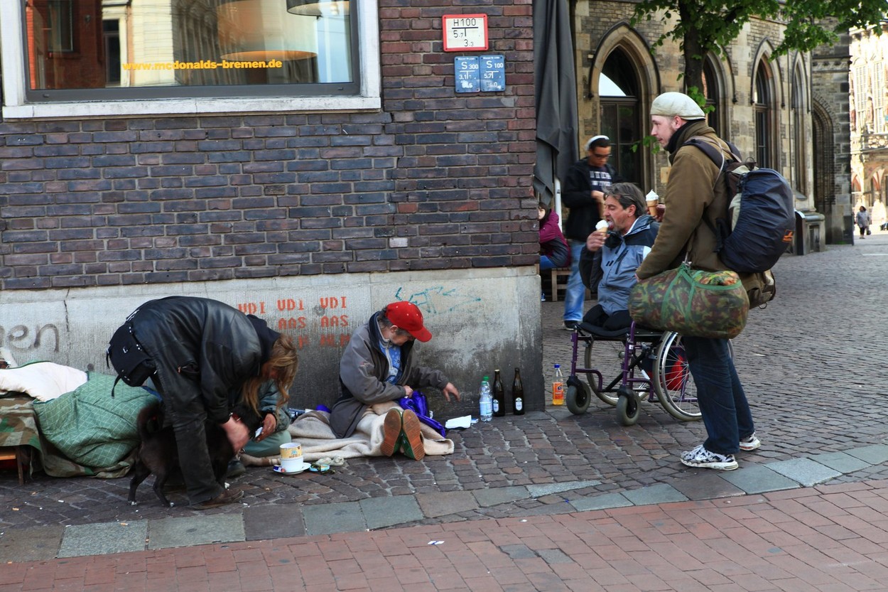 Visitors talking to homeless man on street in Bremen, Germany