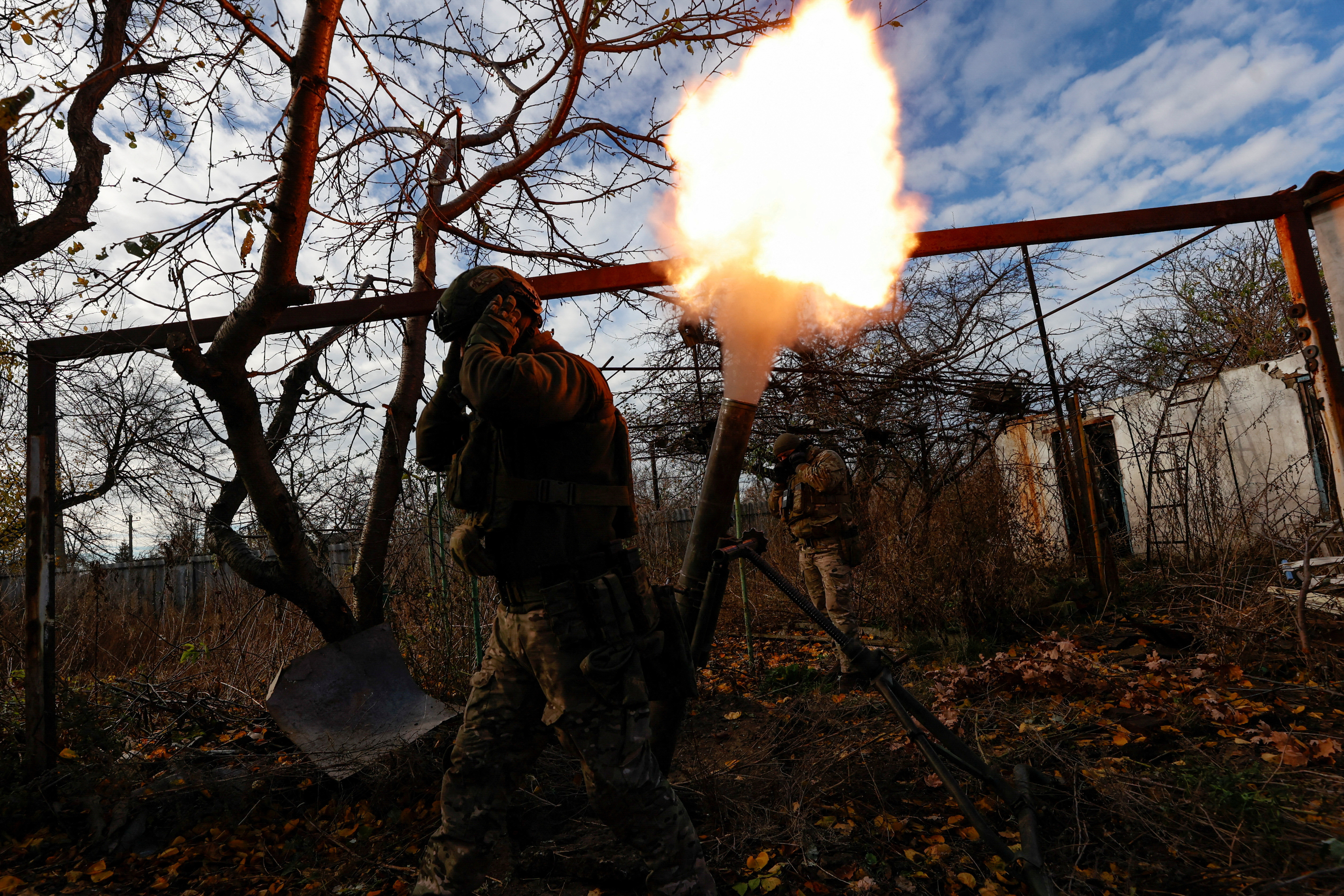 Members of Ukraine's National Guard Omega Special Purpose unit fire a mortar toward Russian troops in the front line town of Avdiivka