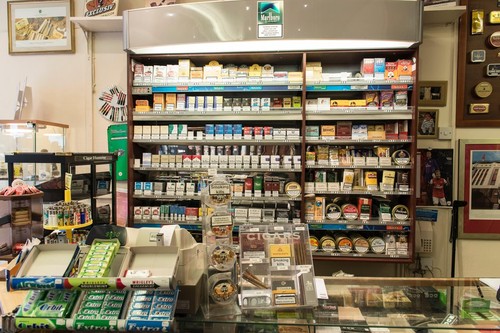 Inside displays of a tobacconist shop that sells cigarettes, lose tobacco, pipe tobacco and papers in a specialist shop