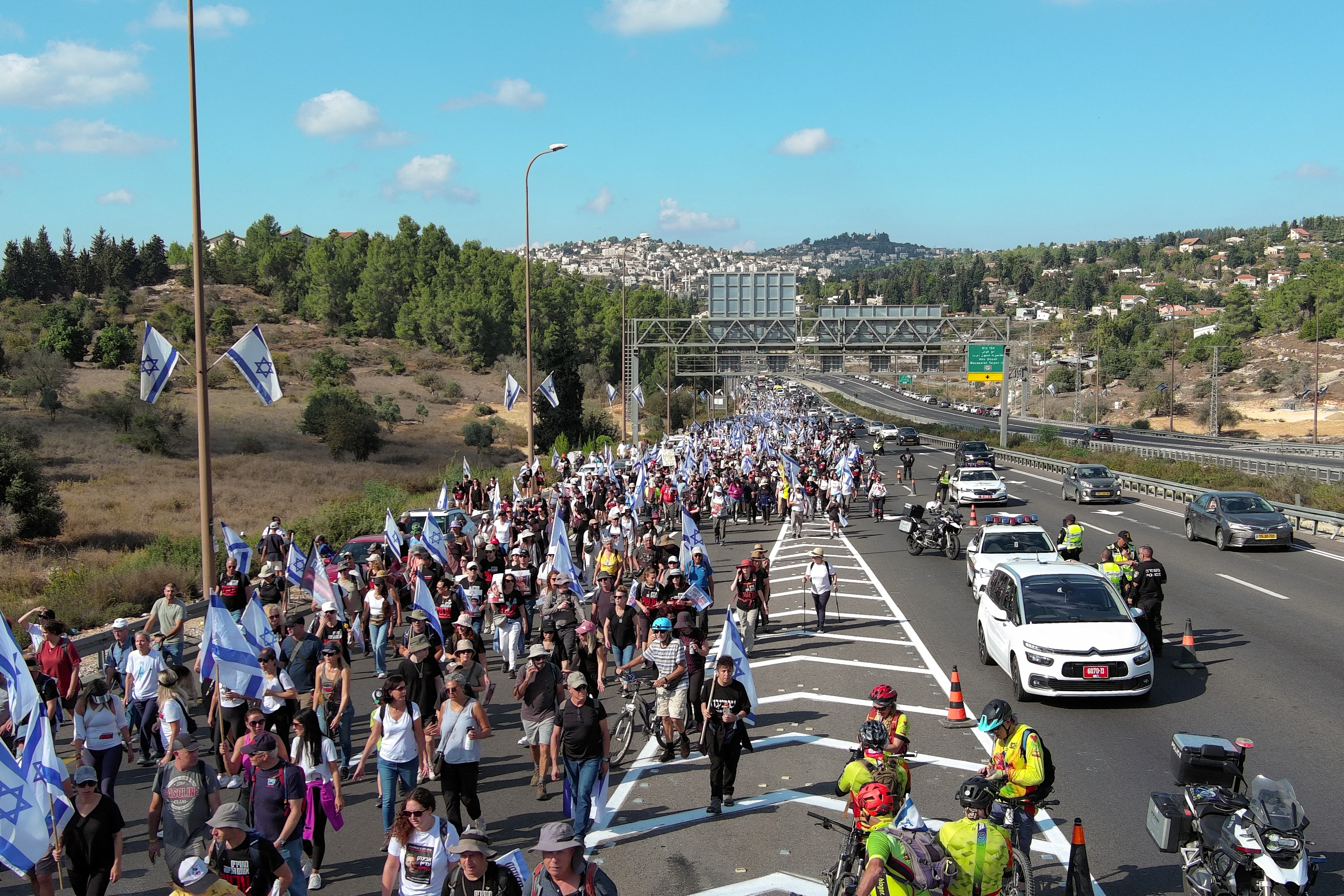 Family members, friends and supporters of Israelis and other nationalities who were taken hostage on October 7 by Palestinian Islamist group Hamas gunmen during a deadly attack, march towards Jerusalem