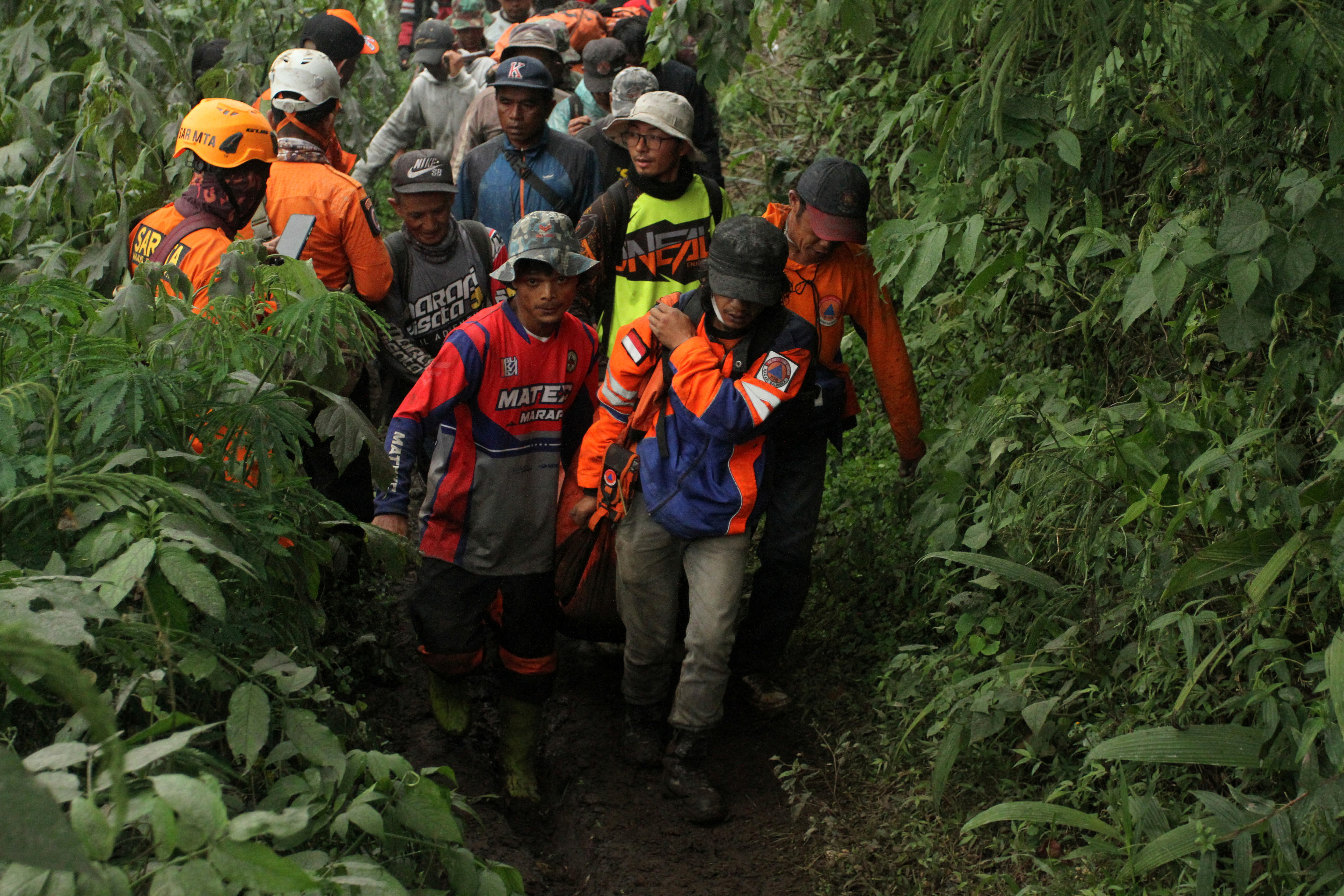 Indonesia rescue teams carry body of Mount Marapi eruption victim in Nagari Batu Plano