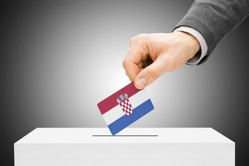 Voting concept - Male inserting flag into ballot box - Croatia