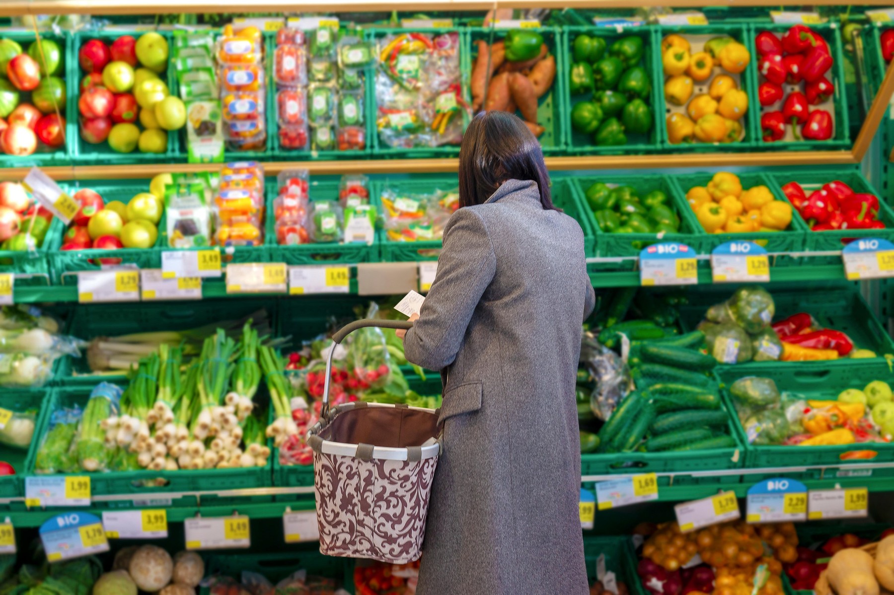 pretty unidentified women shopping vegetables and fruits in supermarket