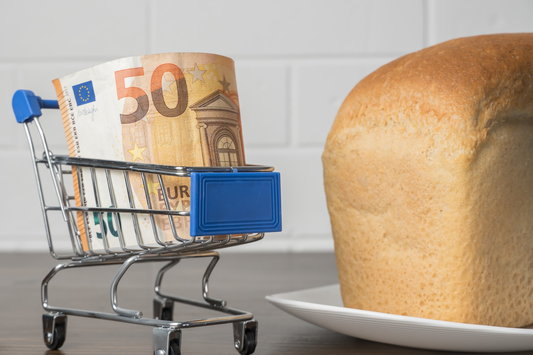 50 Euros in a grocery basket with bread. Rising food prices and groceries in Europe and other countries. Humanitarian assistance