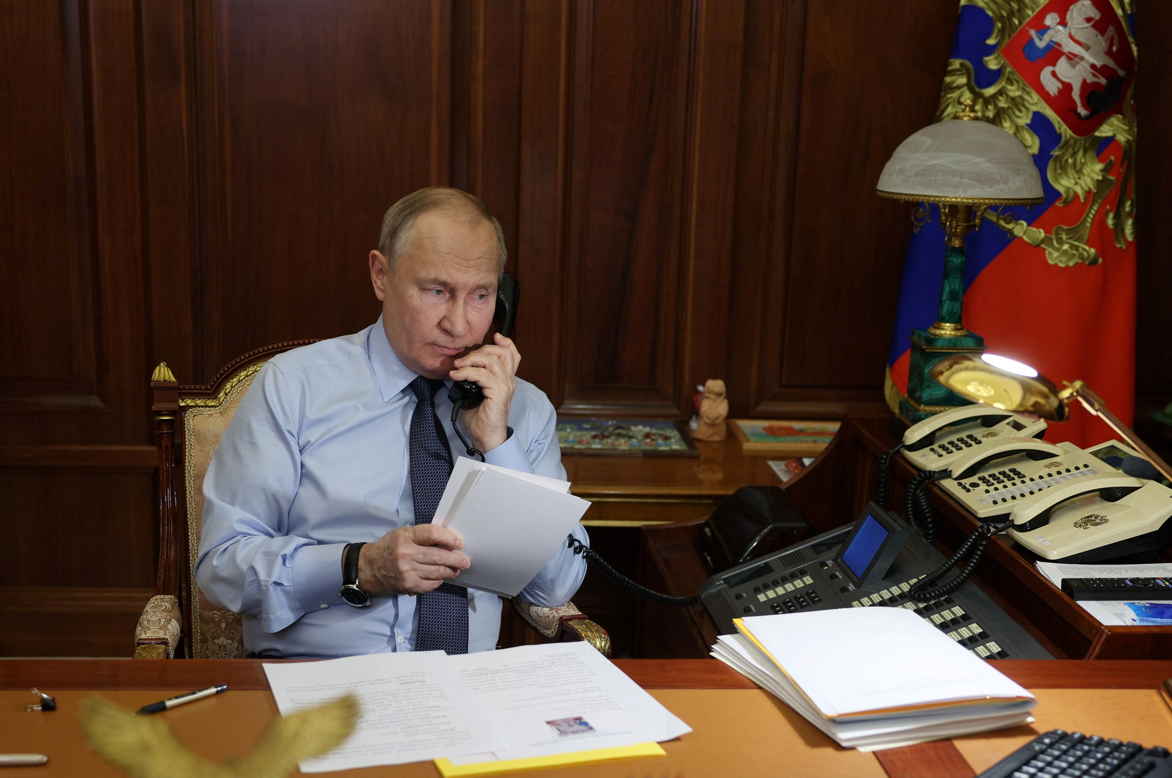Russia's President Putin speaks on the phone with a participant of a charity event in Moscow