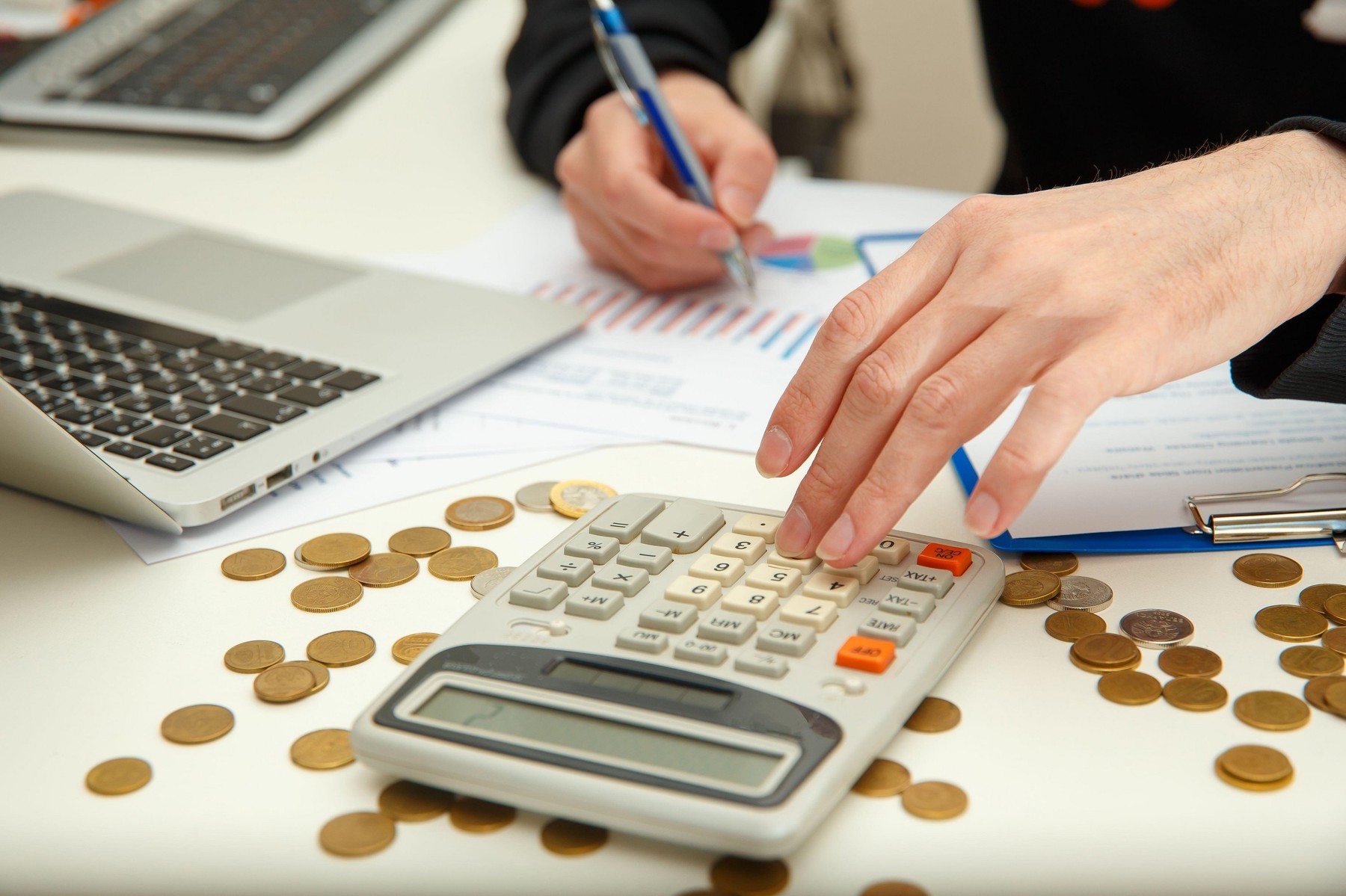 A young man counts profits and taxes. Young man is studying financial documents