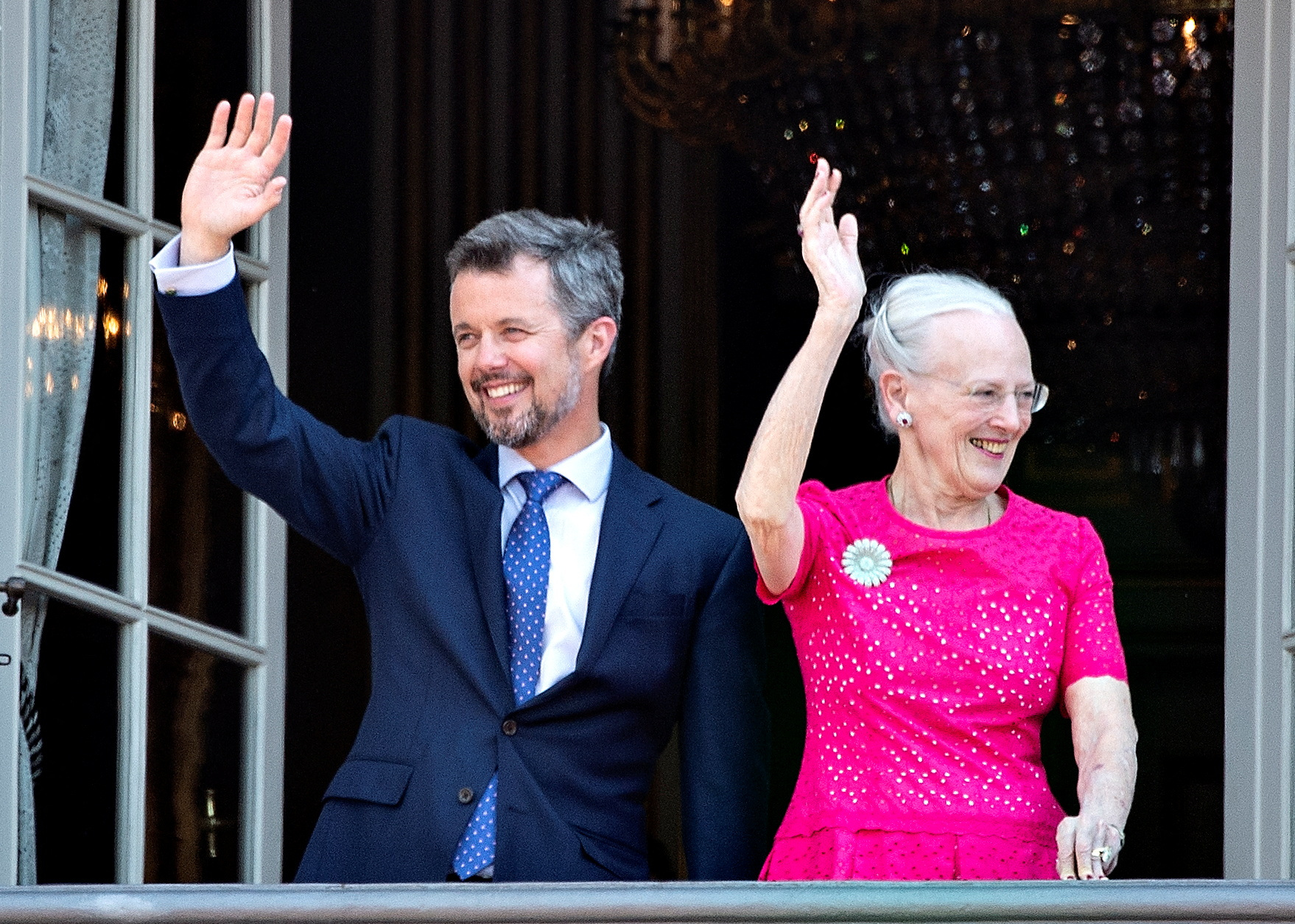 Denmark's Queen Margrethe and Crown Prince Frederik wave from the balcony at Amalienborg Castle in Copenhagen in 2018