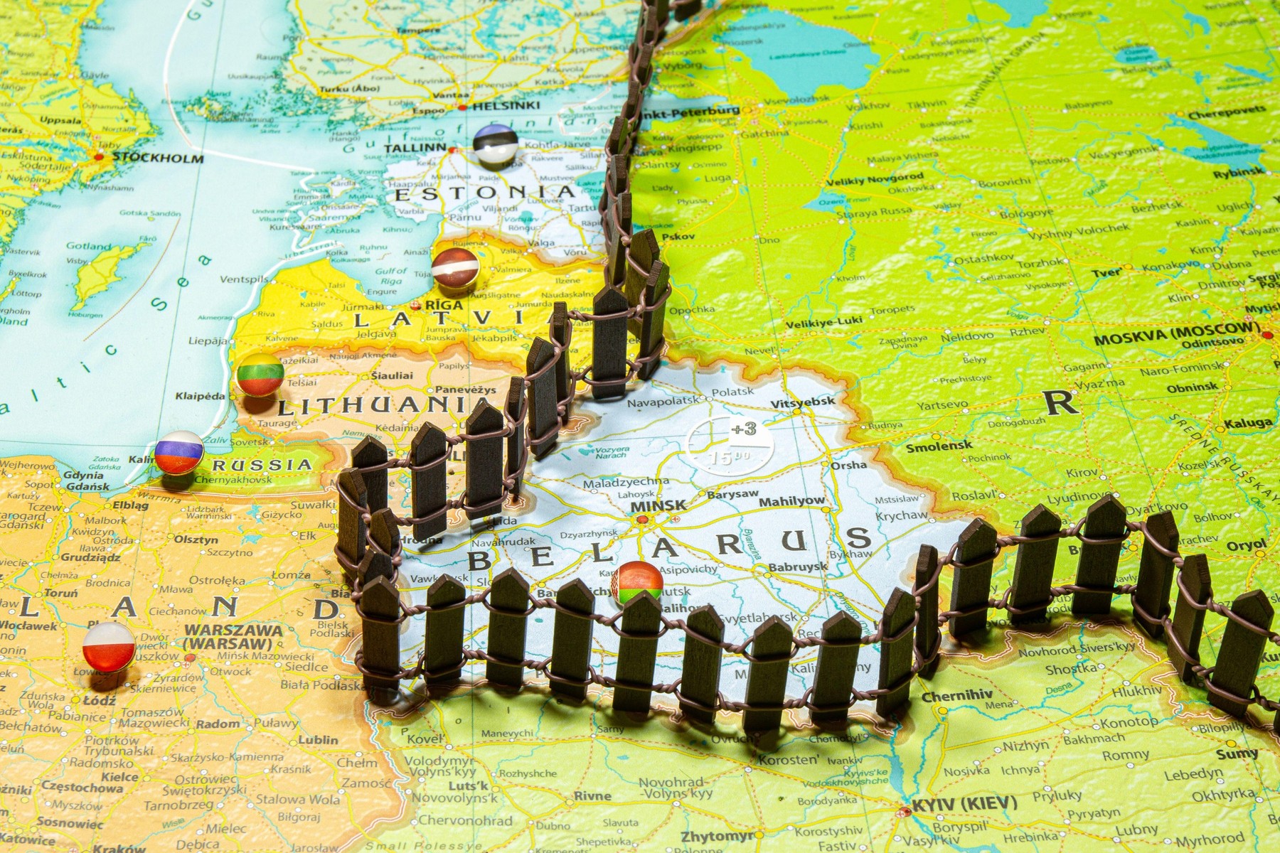 Concept of common border Russia and Belarus. Fence separating from European countries NATO Latvia Lithuania and Estonia. Close up picture on a colorfu