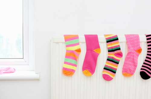 colored socks drying on radiator