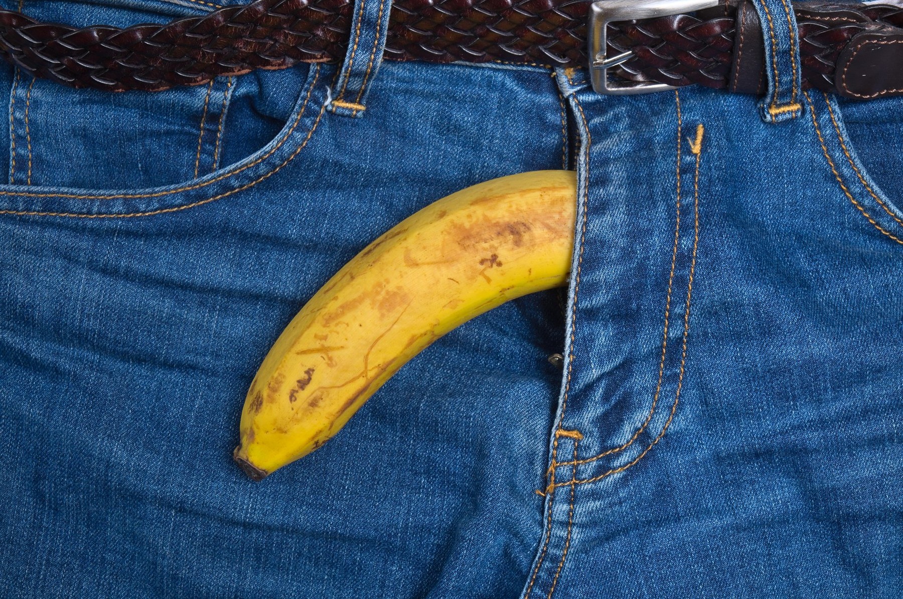 Banana out of men's pants zipper. Sex related theme