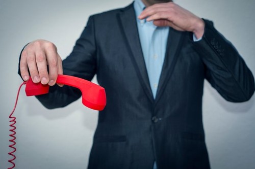 Angry businessman willing to hang-up the phone after conversation