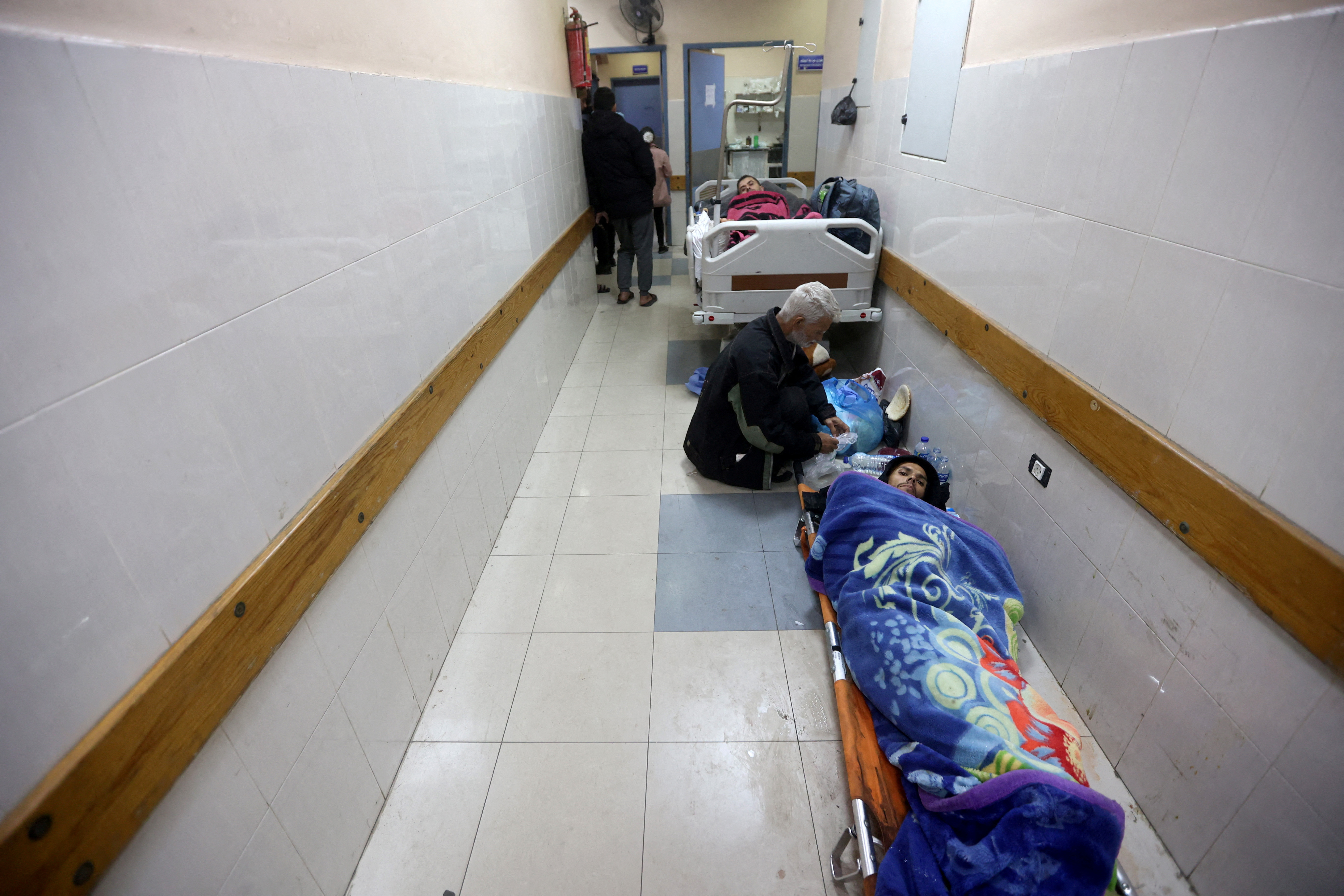 FILE PHOTO: Palestinians wounded in an Israeli strike lie in corridor at Nasser hospital in Khan Younis