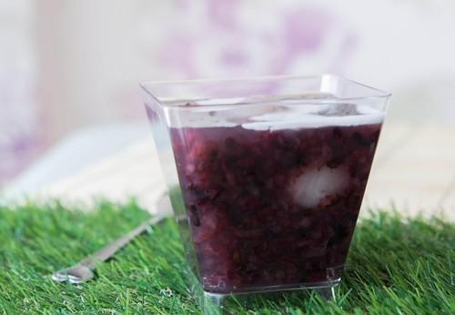 Thai dessert, black sticky rice pudding with longan and coconut cream