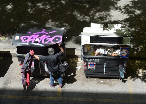 Poor man looking in garbage - Rome