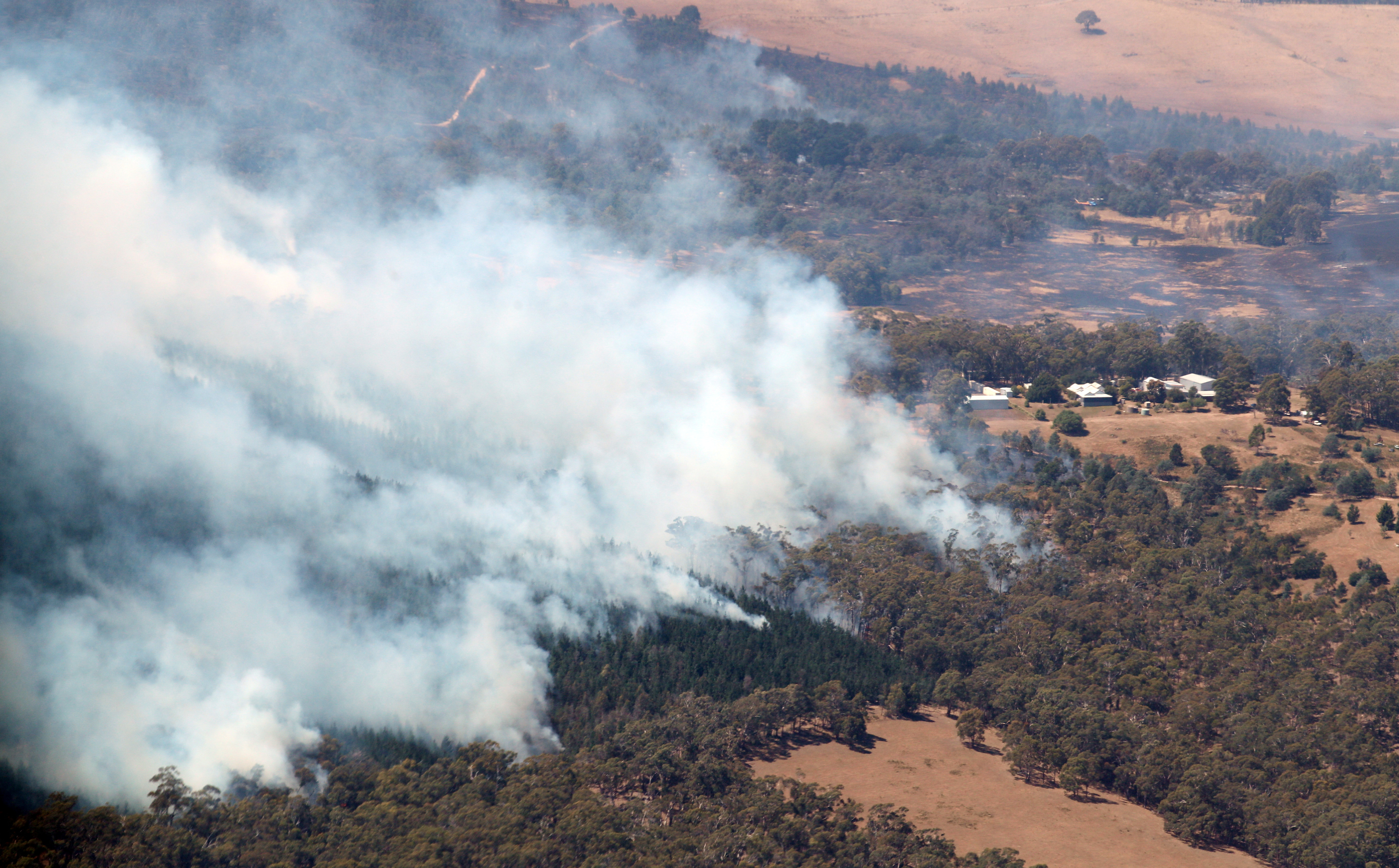 Smoke from bushfires rises north of Beaufort, near Ballarat in Victoria