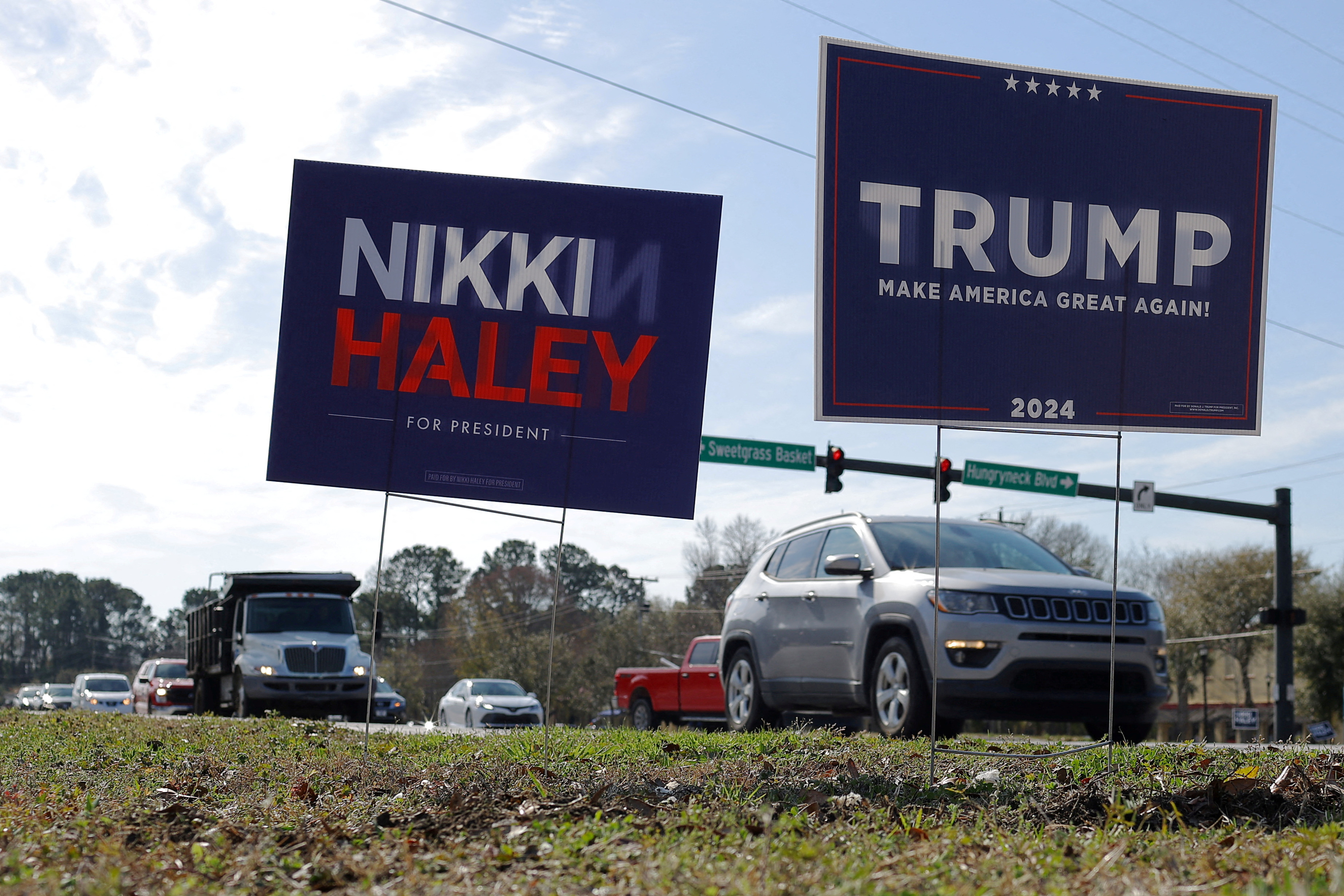 Campaign signs for Republican presidential candidates stand in Mount Pleasant, SC