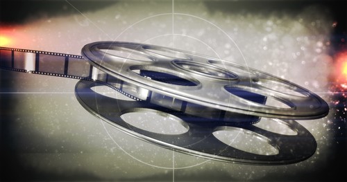 A reel of film is depicted with a dramatic flair, suggesting a cinematic or entertainment theme