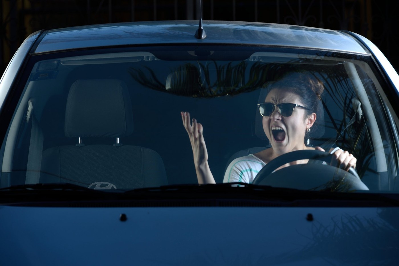 angry woman shouting at someone while driving