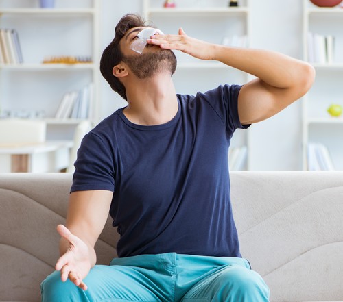 Young man recovering healing at home after plastic surgery nose job. Young man recovering healing at home after plastic surgery nose