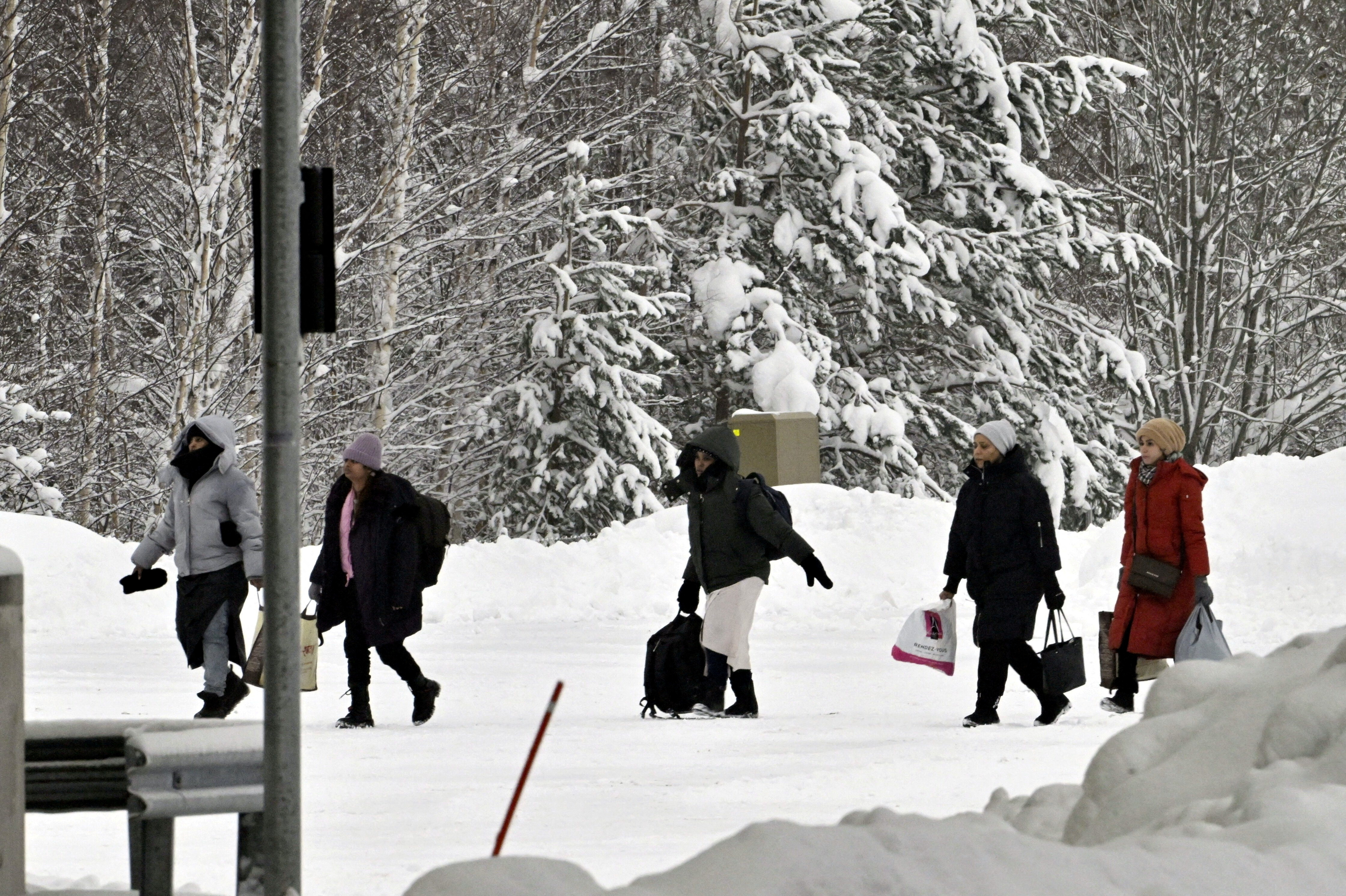 FILE PHOTO: Migrants arrive at the Vaalimaa border check point between Finland and Russia in Virolahti