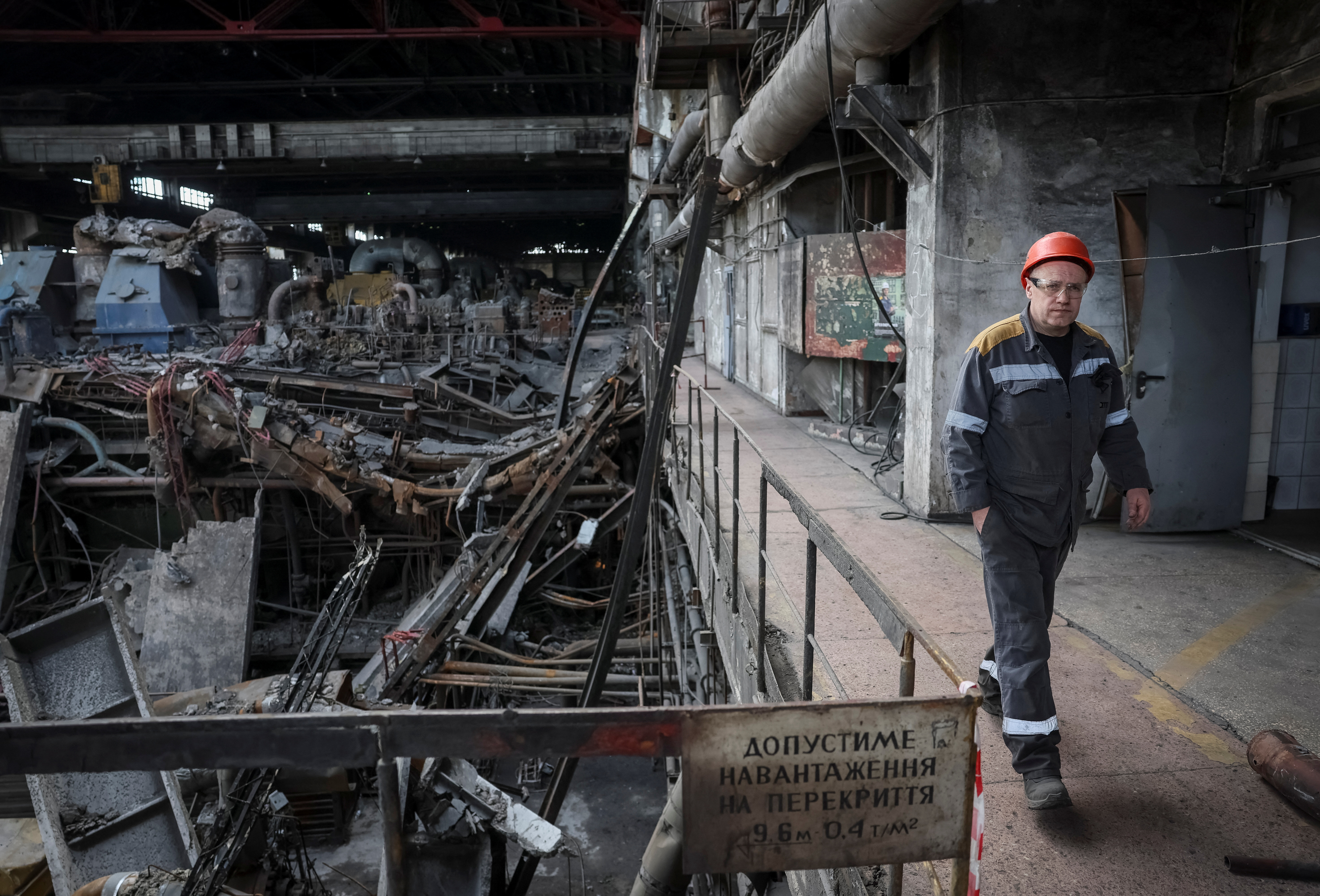 A worker walks at a thermal power plant damaged by recent Russian missile strike