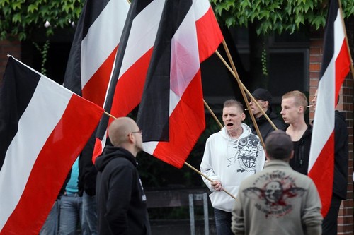 Supporters of the german far right neo-nazi party DIE RECHTE (the rights) waving the flag of the German Empire (Deutsches Reich) in Dortmund/Germany, Sept. 9th. 2015 in protest against the influx of migrants from Asia, Africa and the Middle East to German