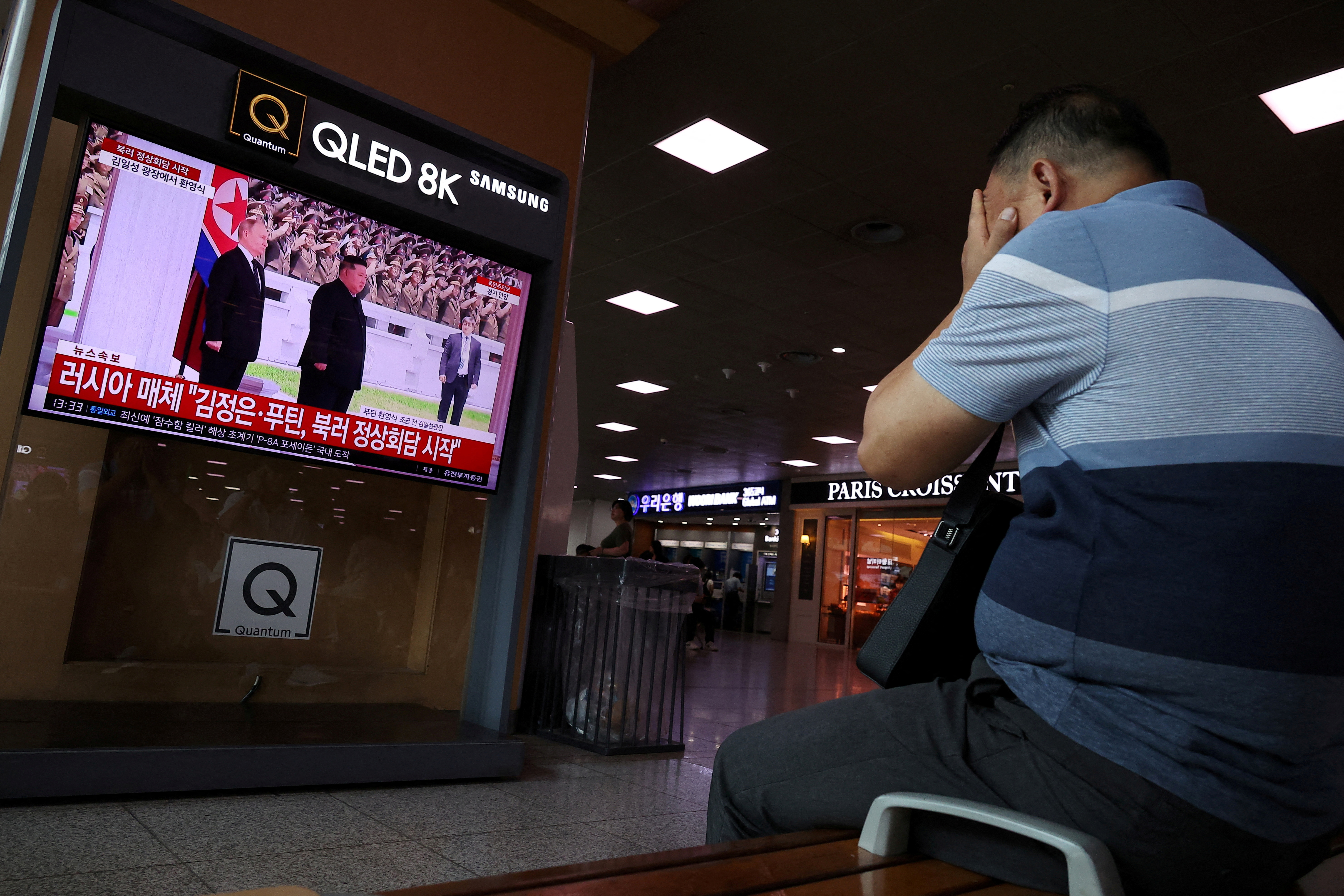 A man watches a TV broadcasting a news report on Russian President Vladimir Putin meeting with North Korean leader Kim Jong Un in Pyongyang, in Seoul