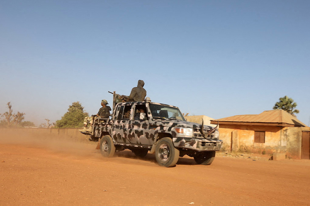 FILE PHOTO: Members of security forces ride a truck as they patrol in Kankara