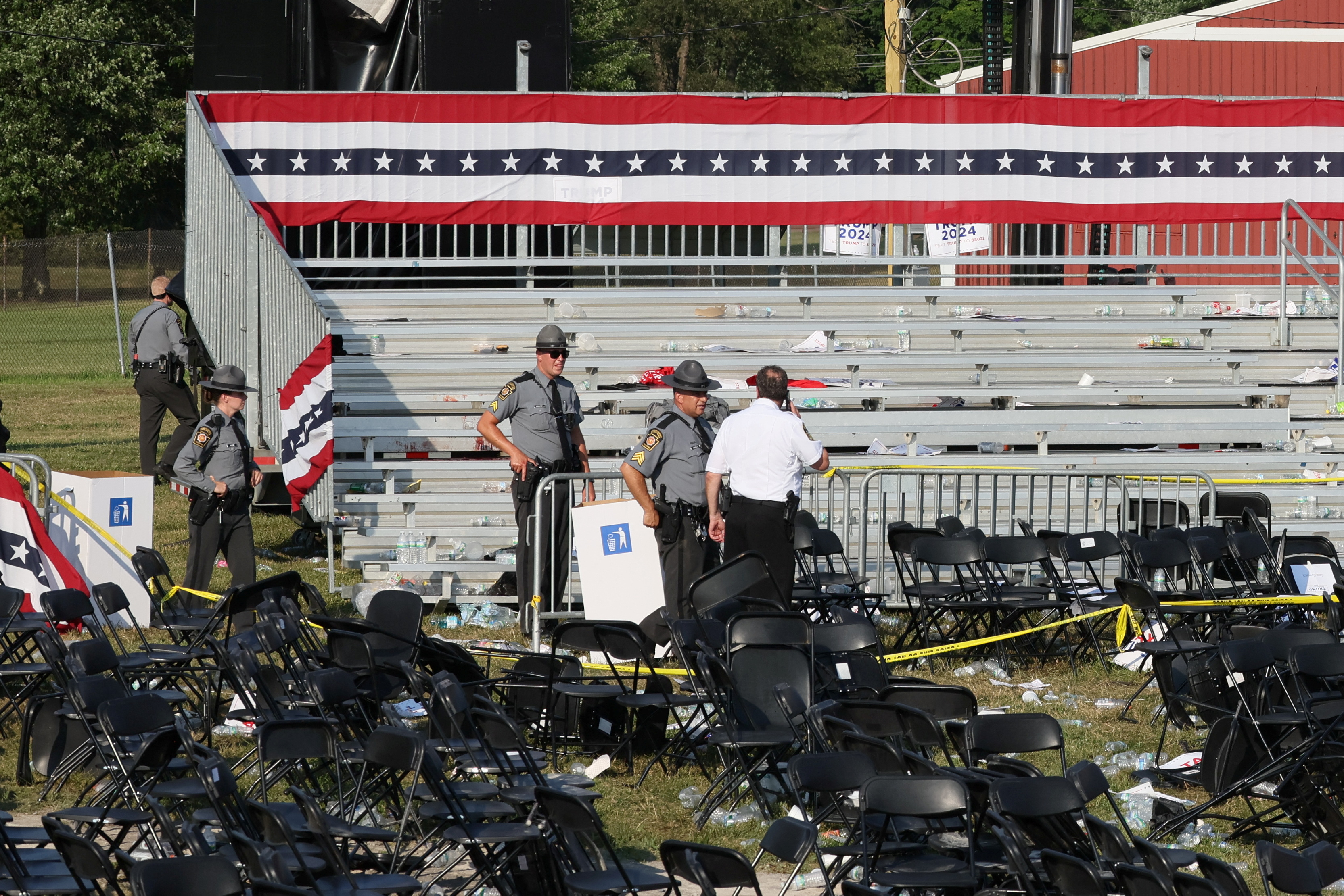 Security personnel inspect the site after gunfire rang out during a campaign rally in Butler