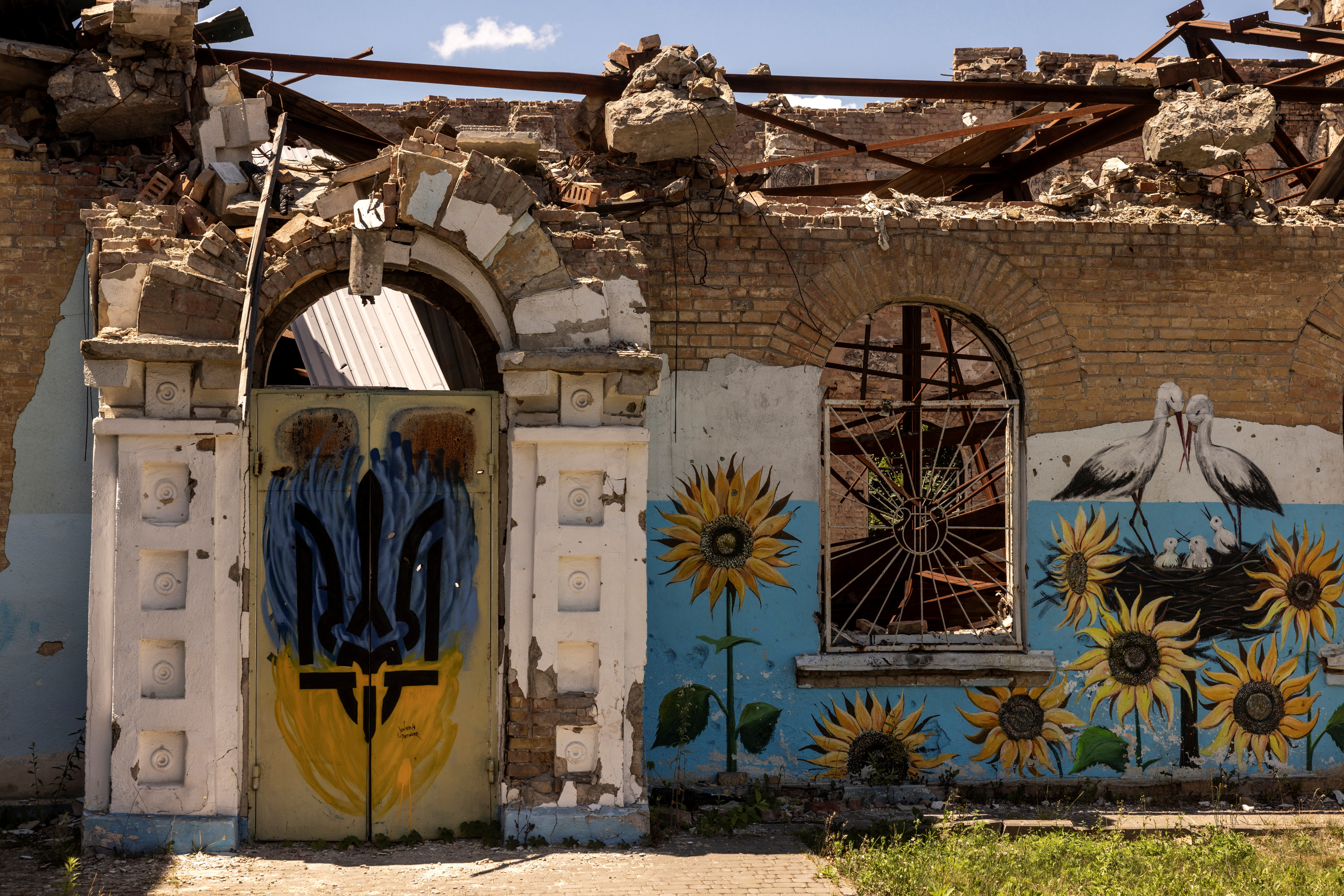 Central House of Culture that was destroyed by Russian shelling is seen outside the damaged Central stadium in Irpin