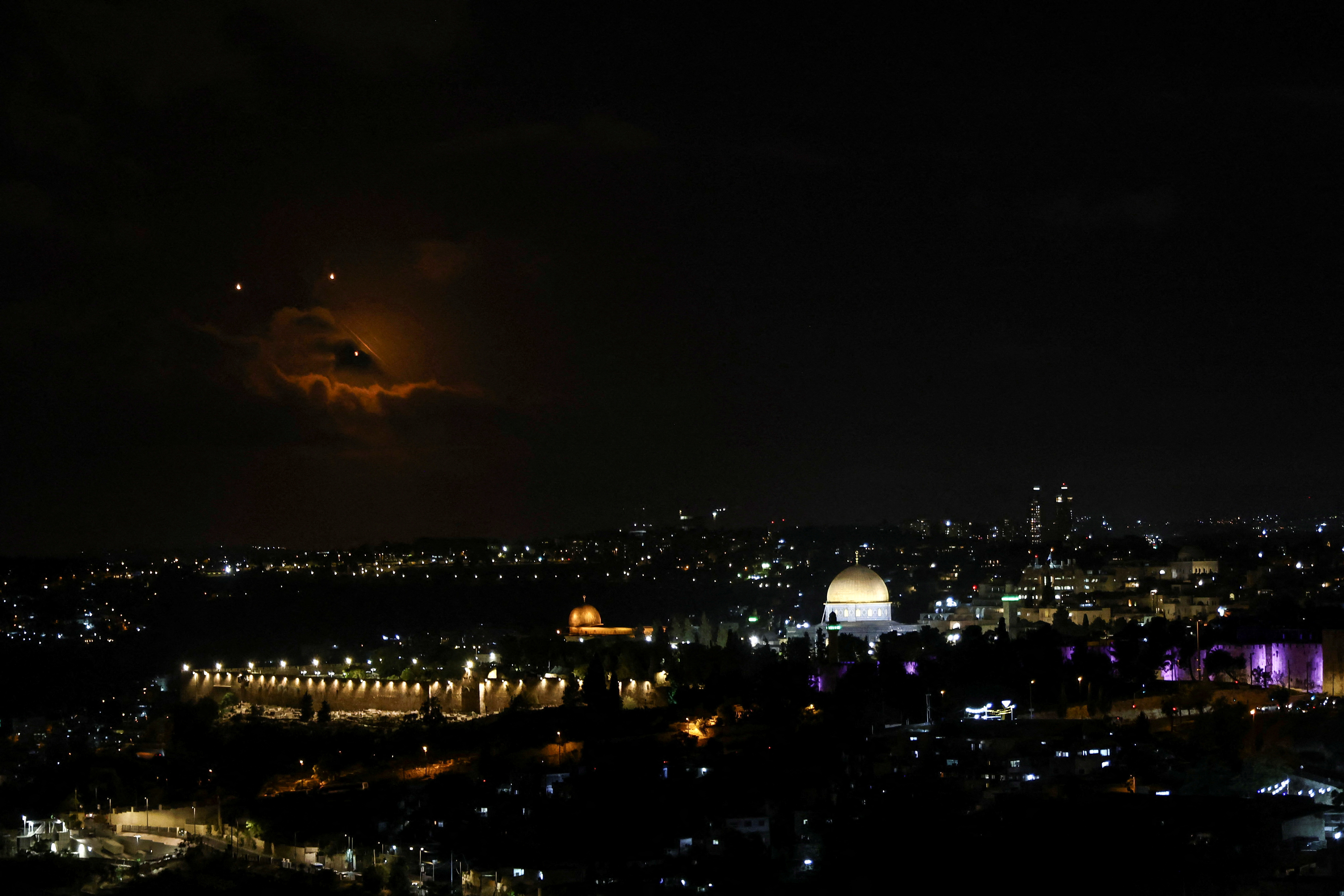 The Dome of the Rock on the Al-Aqsa compound, also known to Jews as the Temple Mount is seen as projectiles fly through the sky, after Iran fired a salvo of ballistic missiles at Israel, as seen from Jerusalem