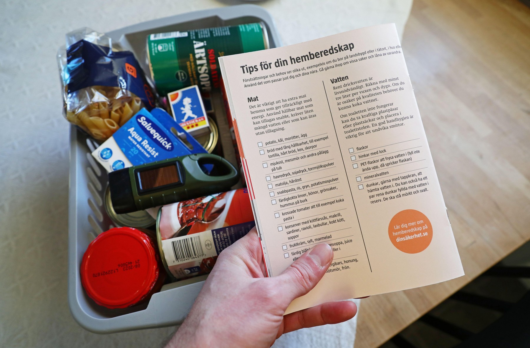 "If the war comes" information and and a box of food and other necessities in a home that might be needed in a crisis or war. Information on tips for your home equipment."If the war comes" (Swedish: Om kriget kommer) is a pamphlet originally prepared by