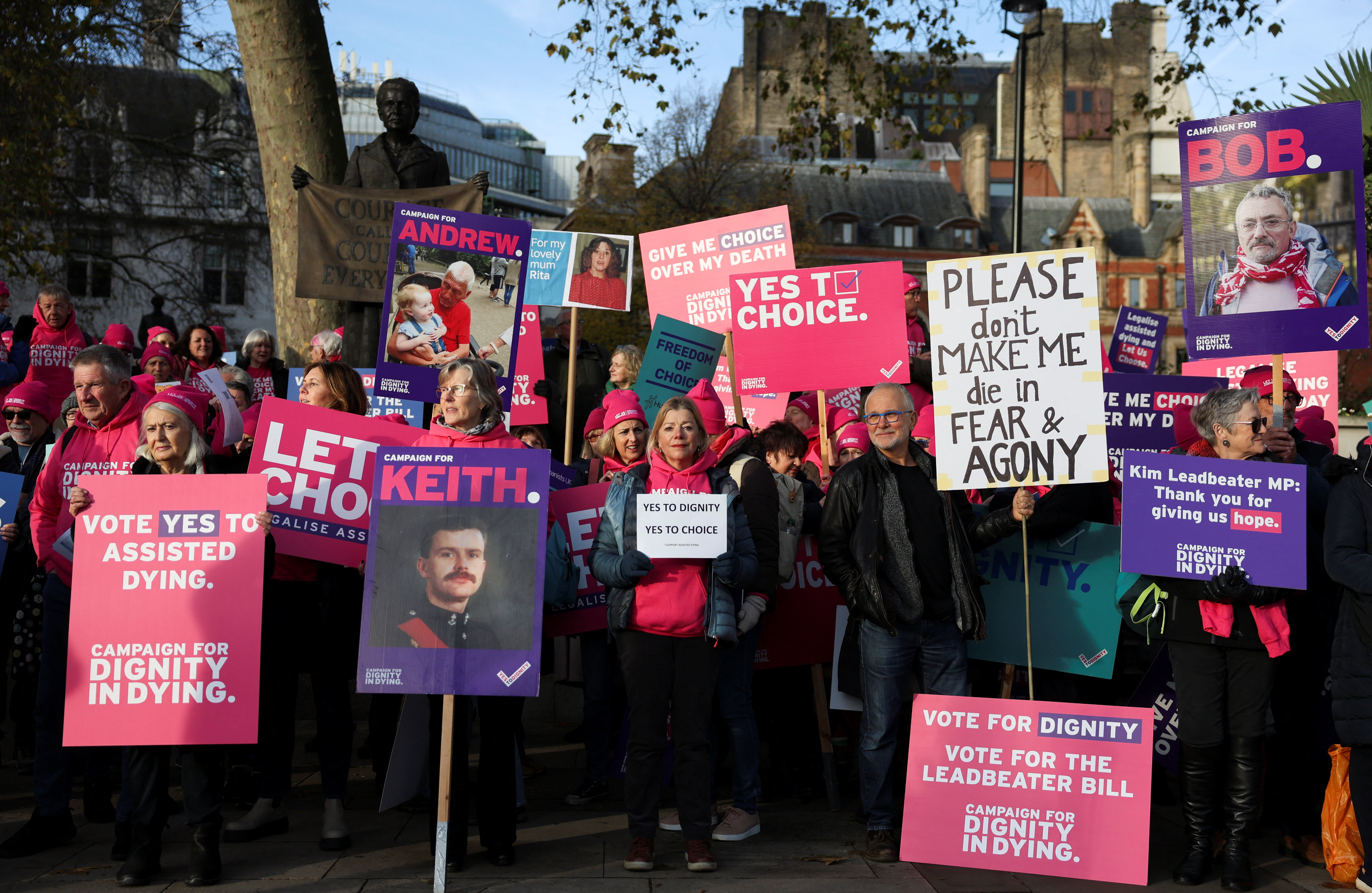 Protestors gather as British lawmakers debate the assisted dying law, in London