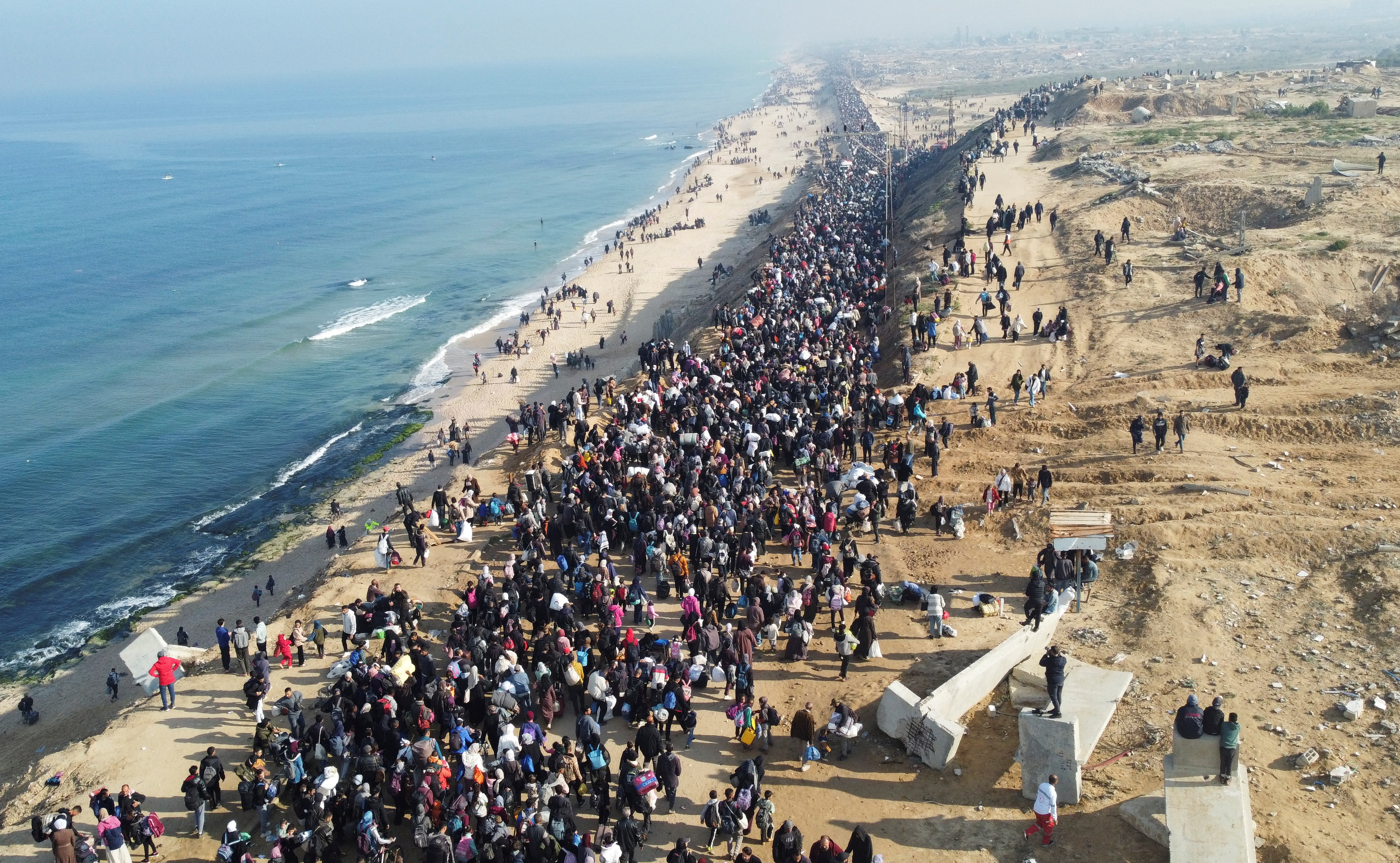 Displaced Palestinians make their way back to their homes in northern Gaza, amid a ceasefire between Israel and Hamas, in the central Gaza Strip