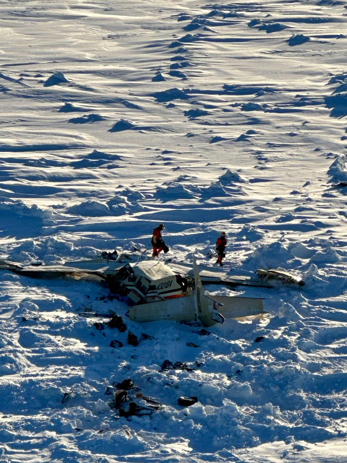 Authorities inspect the wreckage of the Cessna 208B Grand Caravan aircraft operated by Berring Air, near Nome