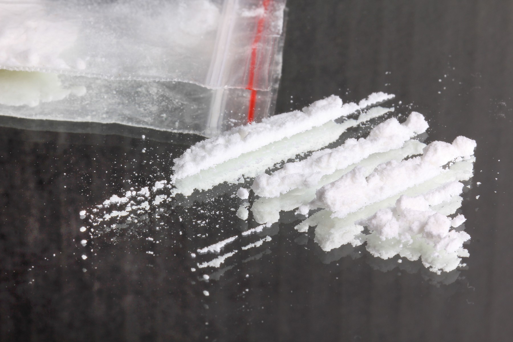 Cocaine in packet, closeup on mirror
