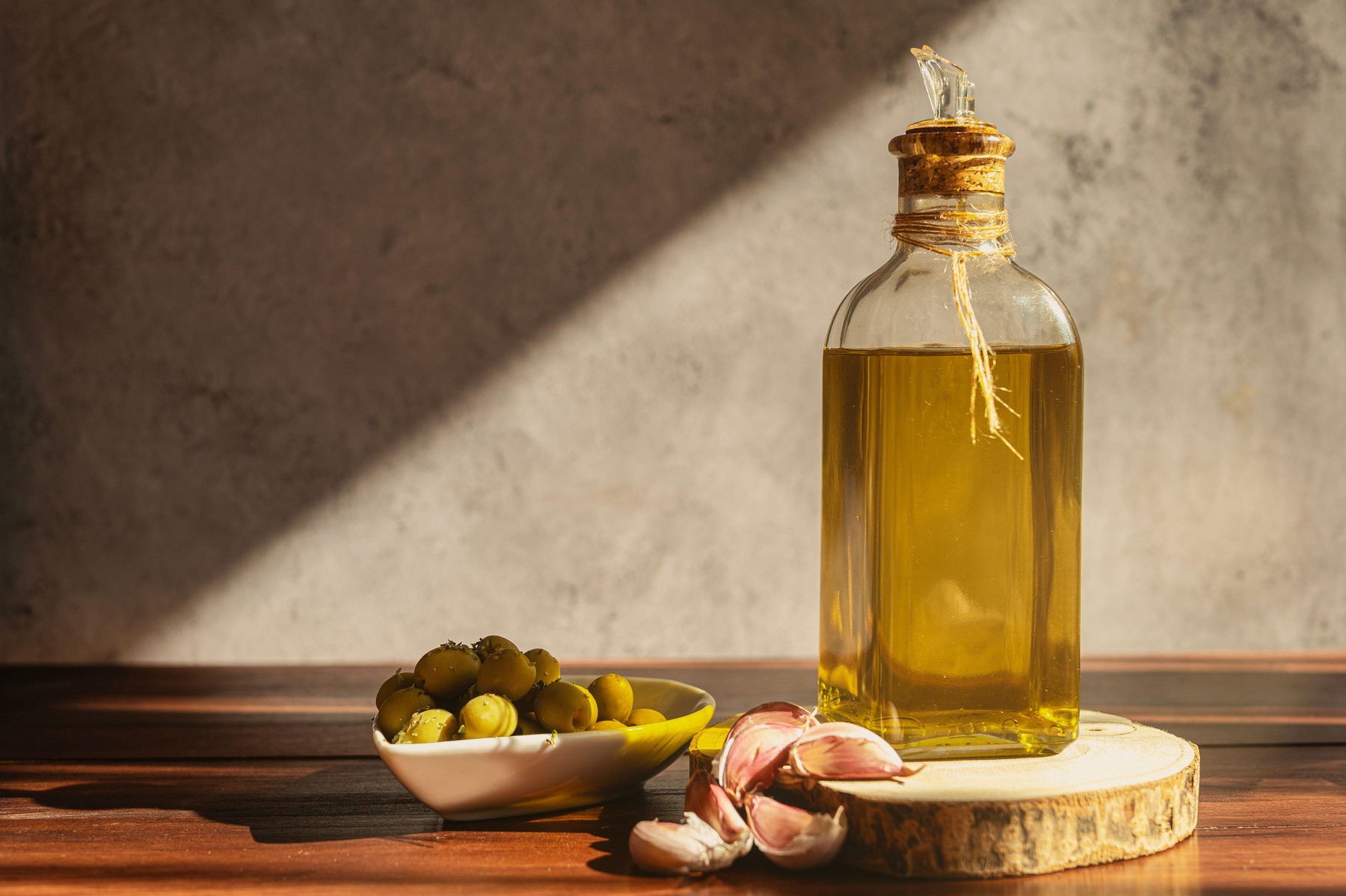 Olive oil bottle with olives and garlic