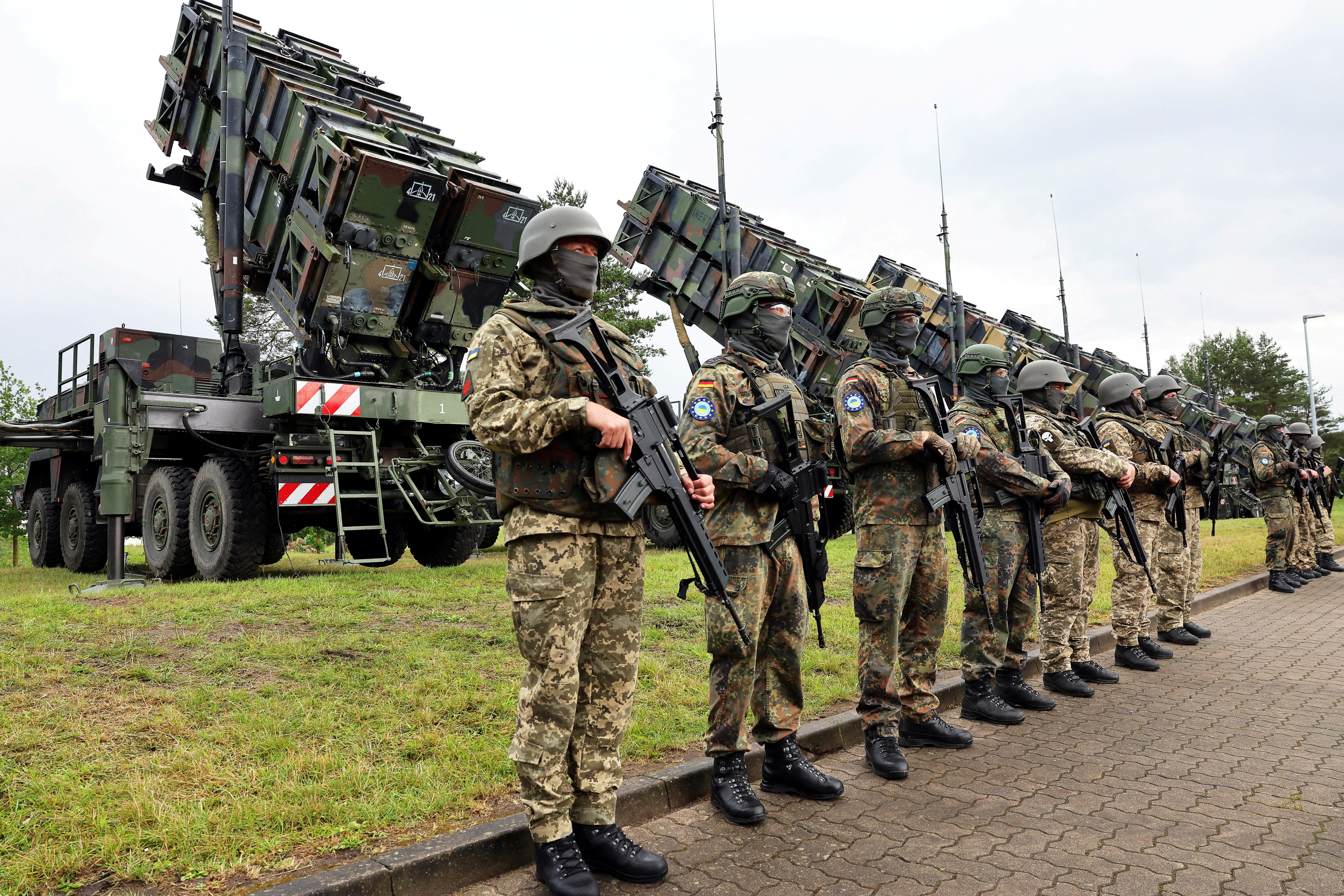 Soldiers stand during Ukrainian President Volodymyr Zelenskiy's visit to a military