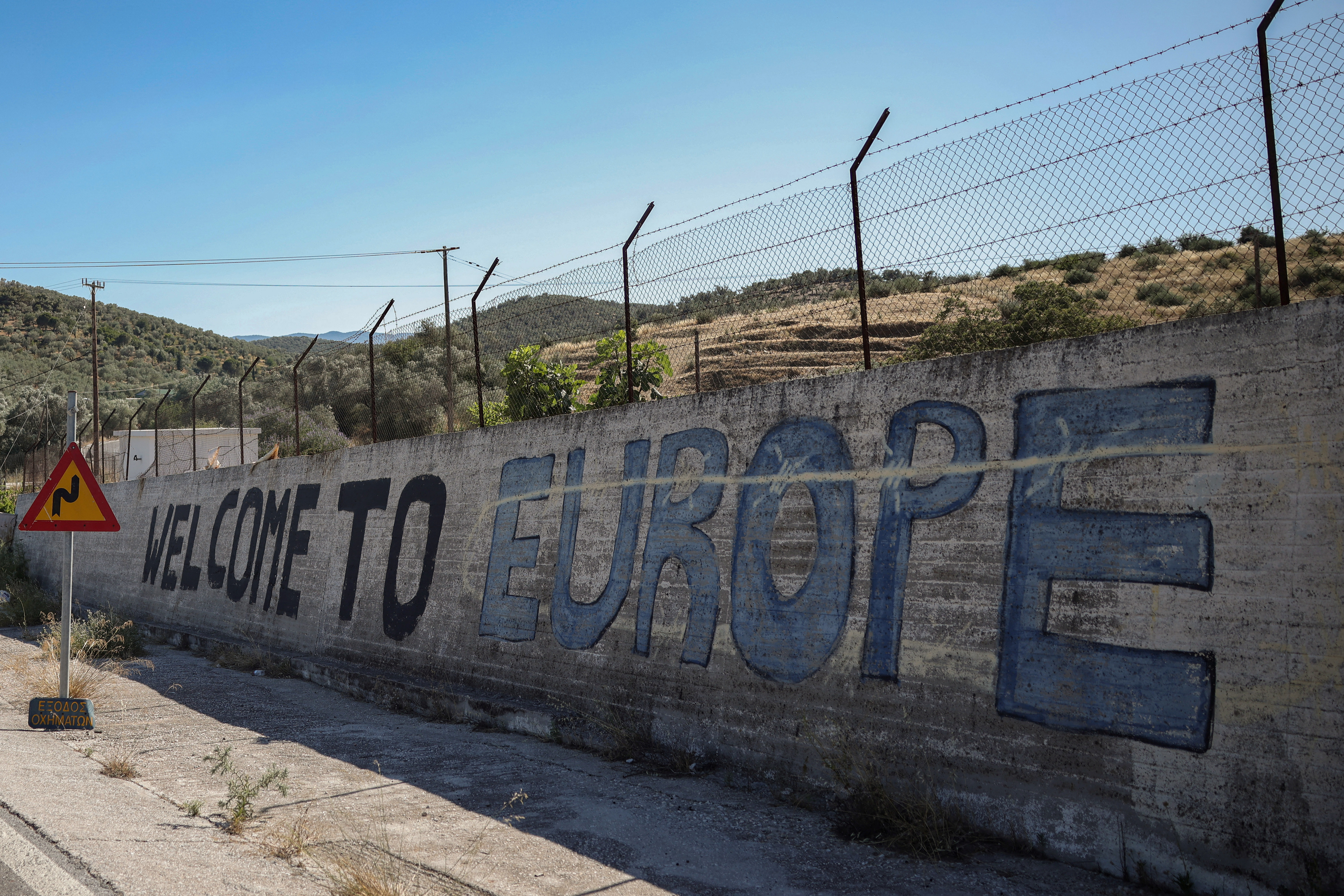 A message is written on a wall of the Moria refugee camp, burned in 2020, near the village of Moria, Lesbos island, Greece June 26,2025.