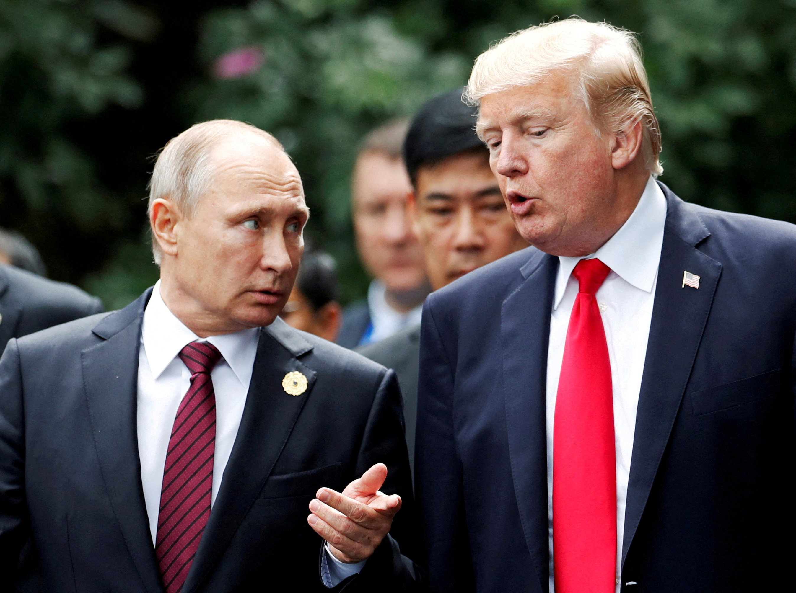 U.S. President Donald Trump and Russia's President Vladimir Putin talk during the family photo session at the APEC Summit in Danang, Vietnam