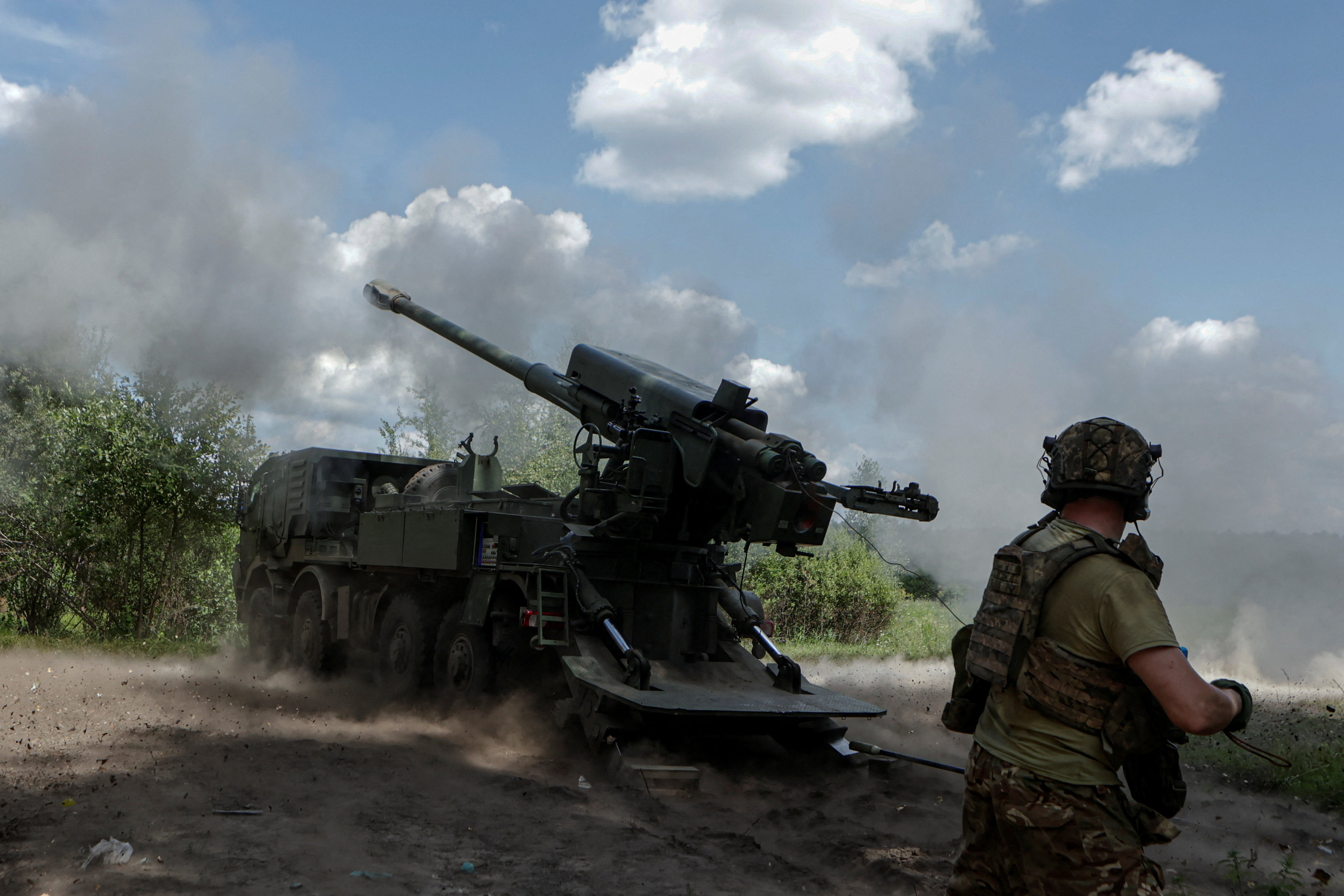 Service members of the 48th Separate Artillery Brigade fire a 2S22 Bohdana self-propelled howitzer towards Russian troops near a front line
