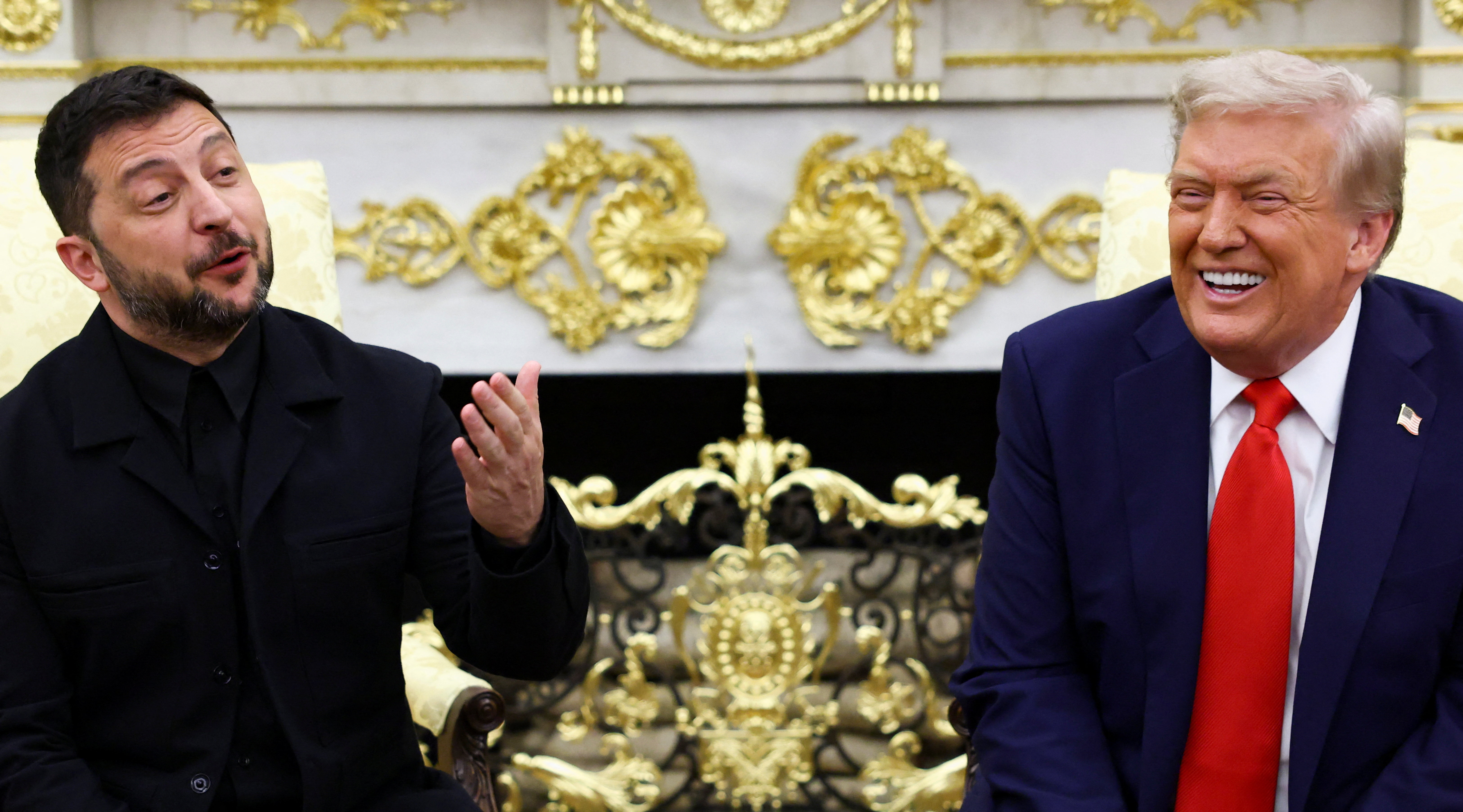 U.S. President Donald Trump laughs while Ukrainian President Volodymyr Zelenskiy gestures as they meet at the Oval Office of the White House