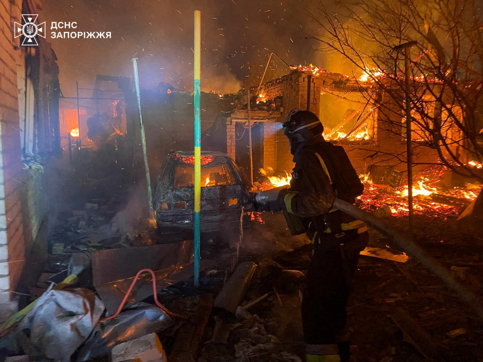 A firefighter works at the site of an apartment building hit during a Russian drone and missile strike