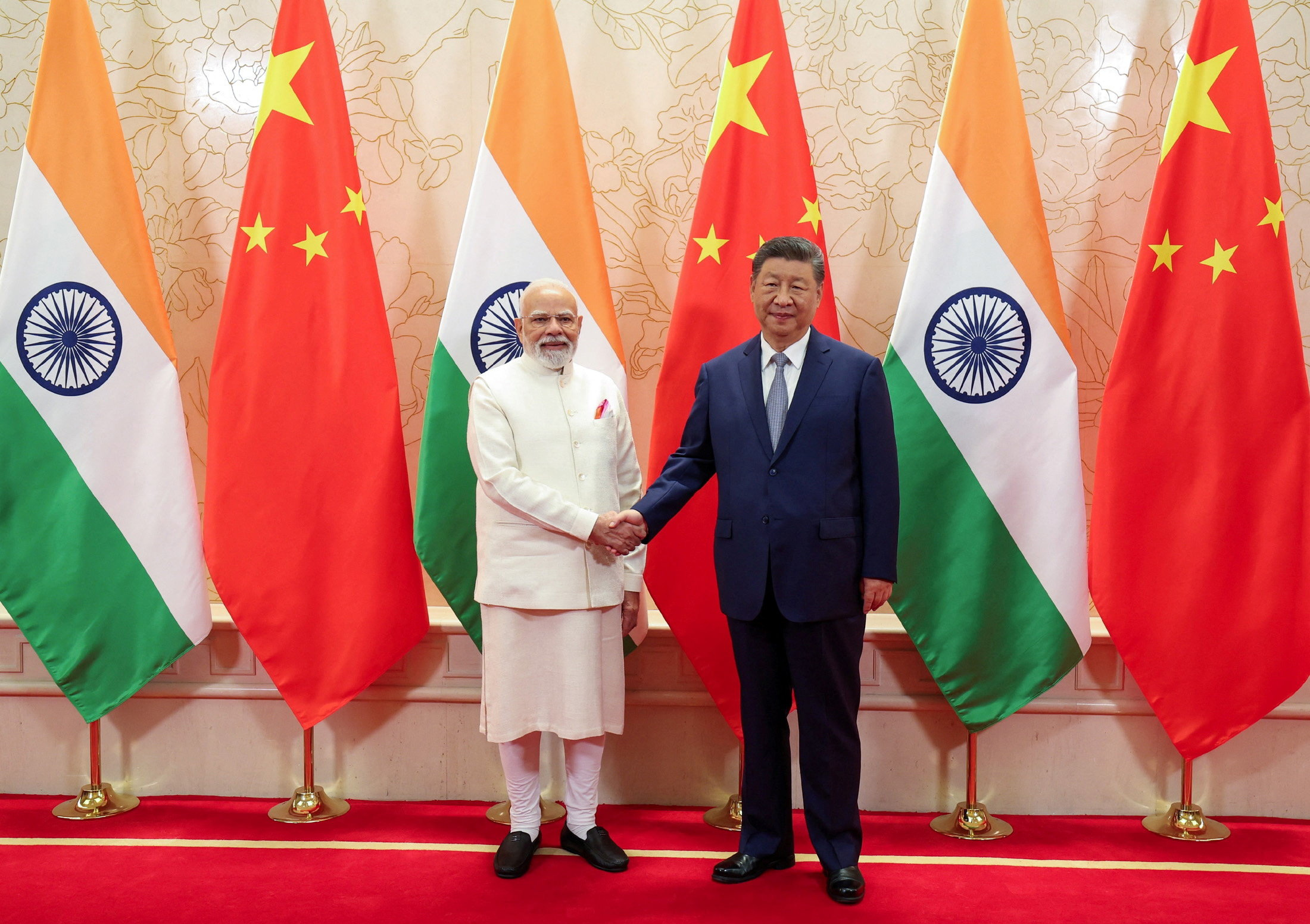 India's Prime Minister Narendra Modi shakes hands with Chinese President Xi Jinping