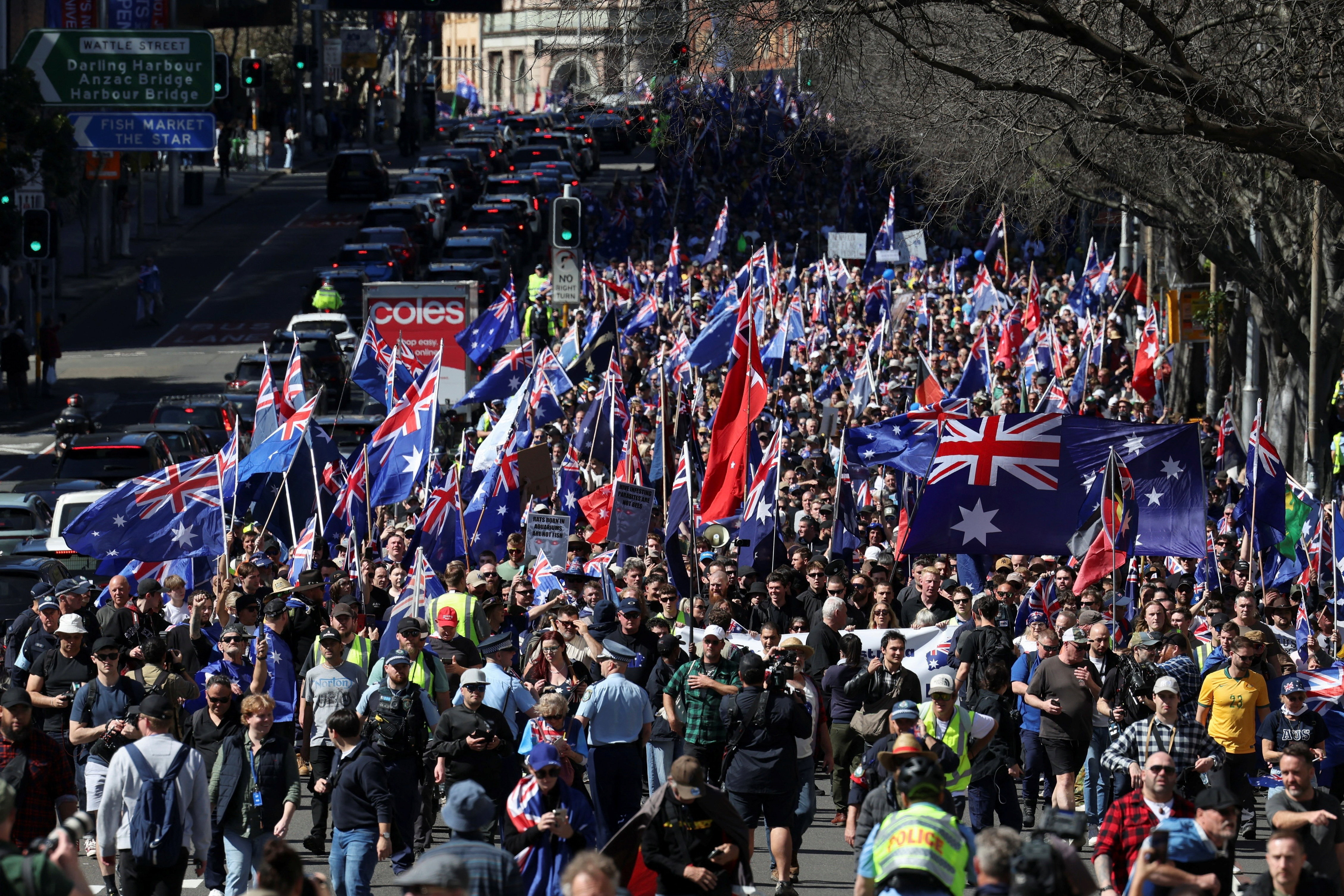 Demonstrators carry Australian flags during the 'March for Australia' anti-immigration rally, in Sydney, Australia, August 31, 2025. REUTERS/Hollie Adams