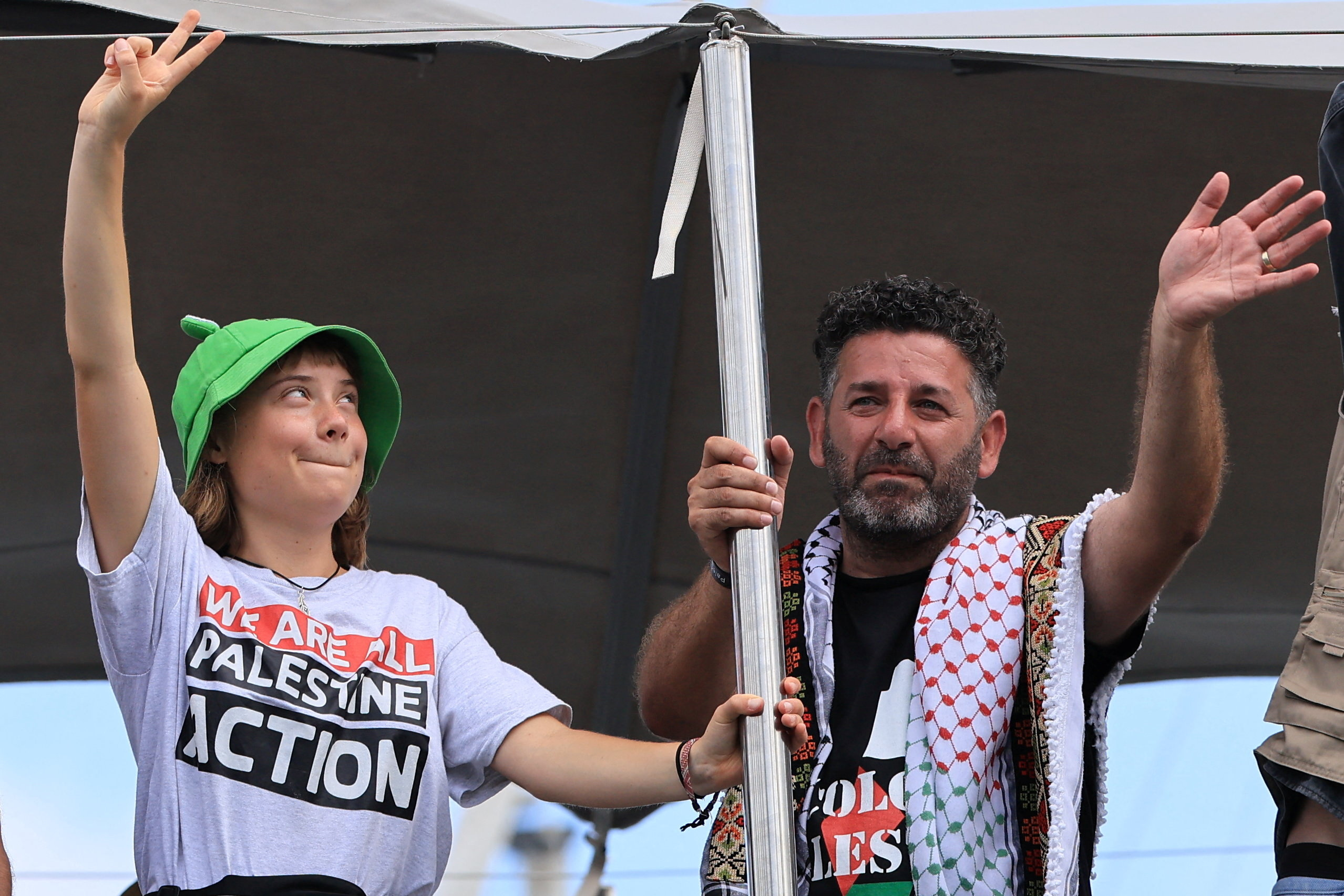 Greta Thunberg and Saif Abukeshek wave as they depart on the Global Sumud Flotilla, a humanitarian expedition to Gaza, from the port of Barcelona, Spain, August 31, 2025.